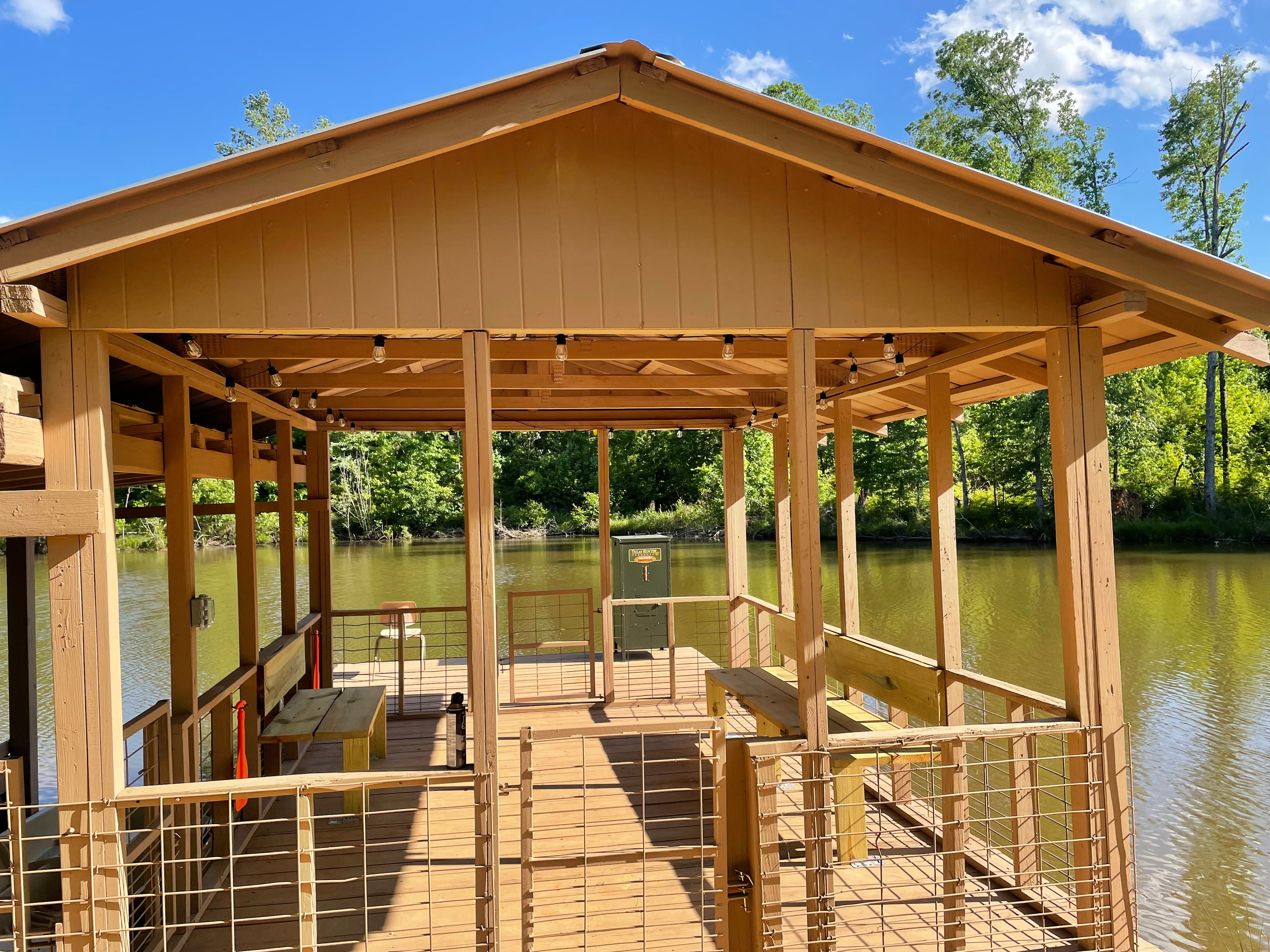 Covered fishing boat dock with benches