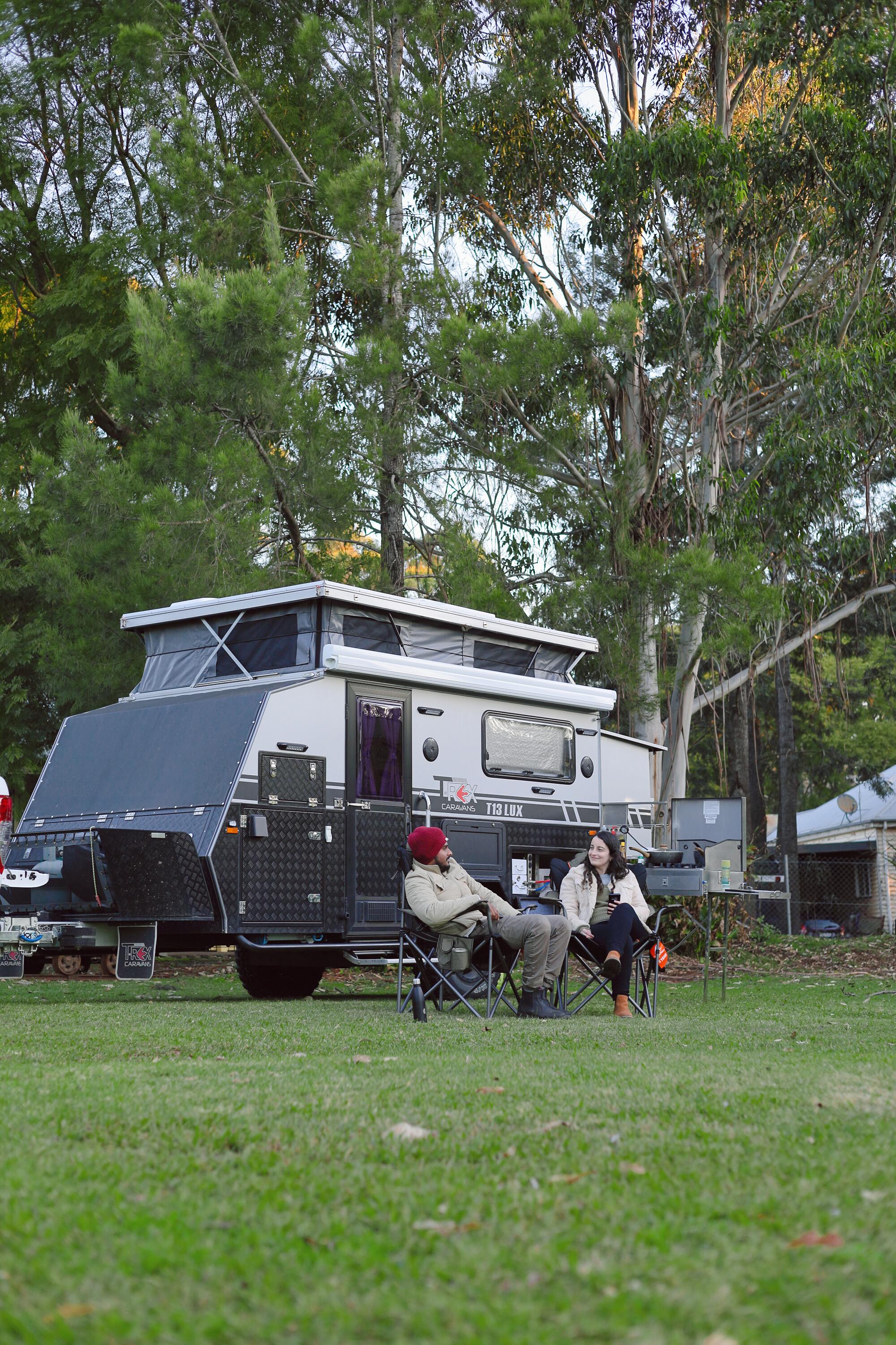 The campsite is leafy with manicured lawns and gardens.