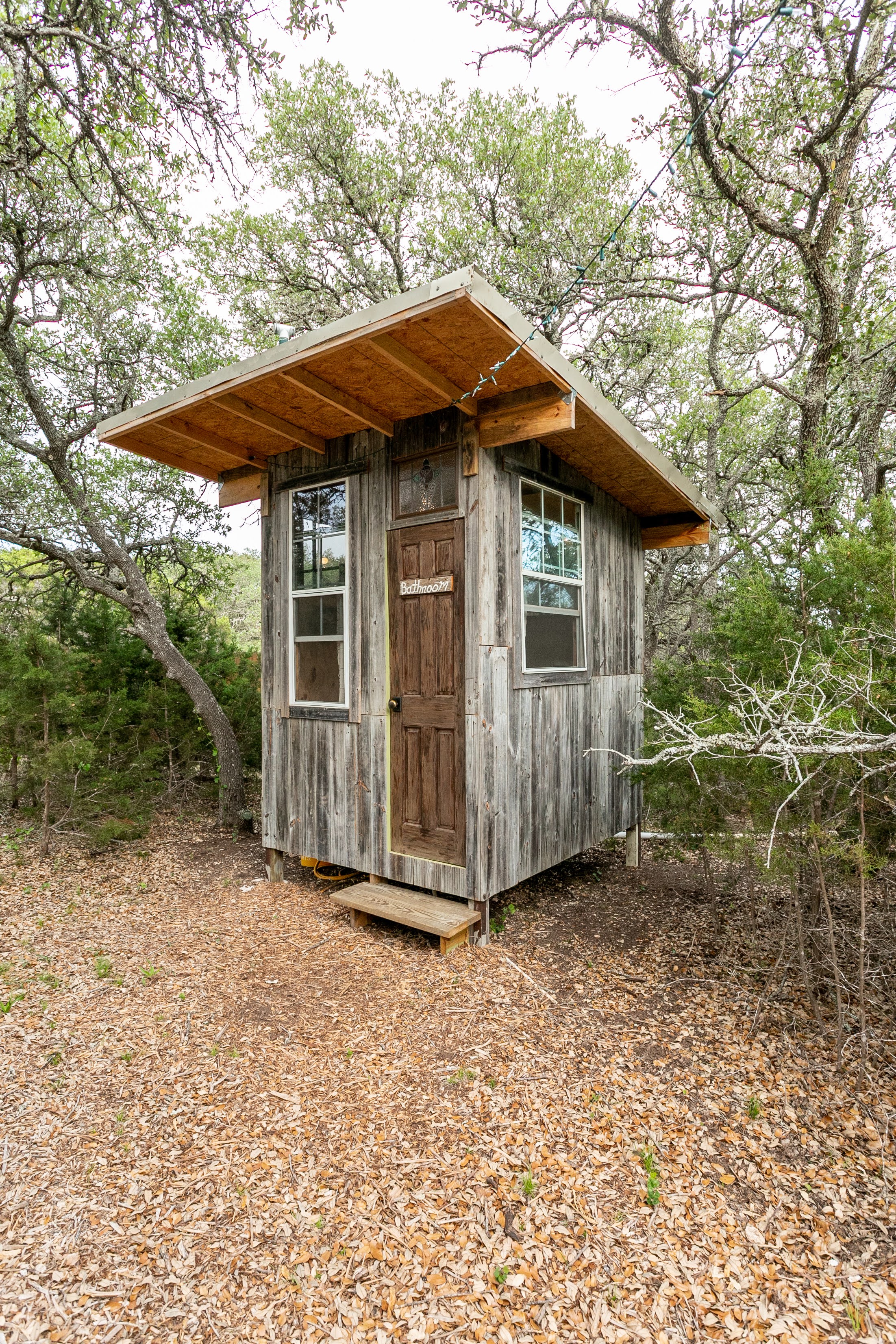 The "outhouse" is made from reclaimed fence wood! There's a composting toilet, sink, and shower. 
