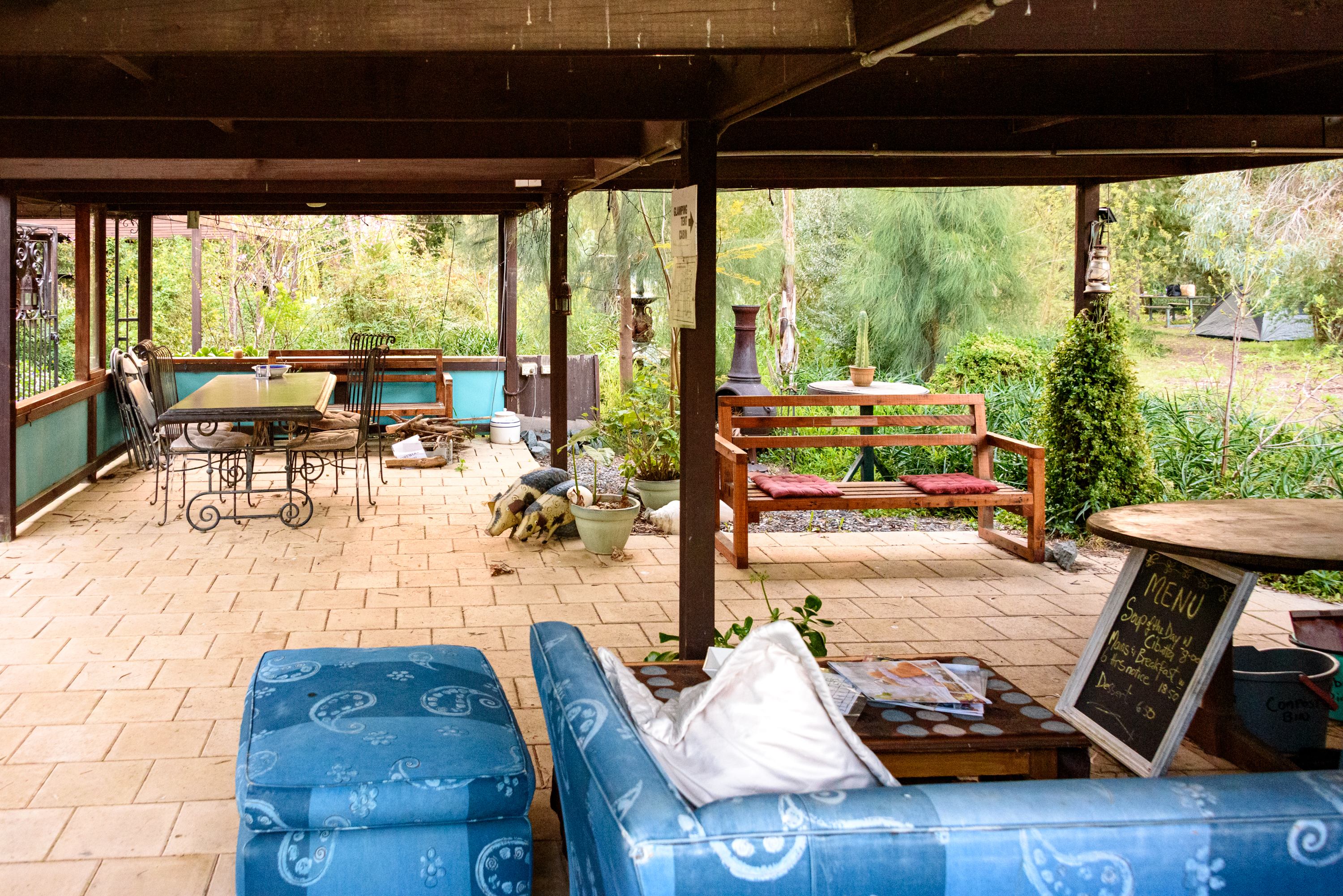 Undercover shared area with lots of seating, a BBQ and basic kitchen facilities