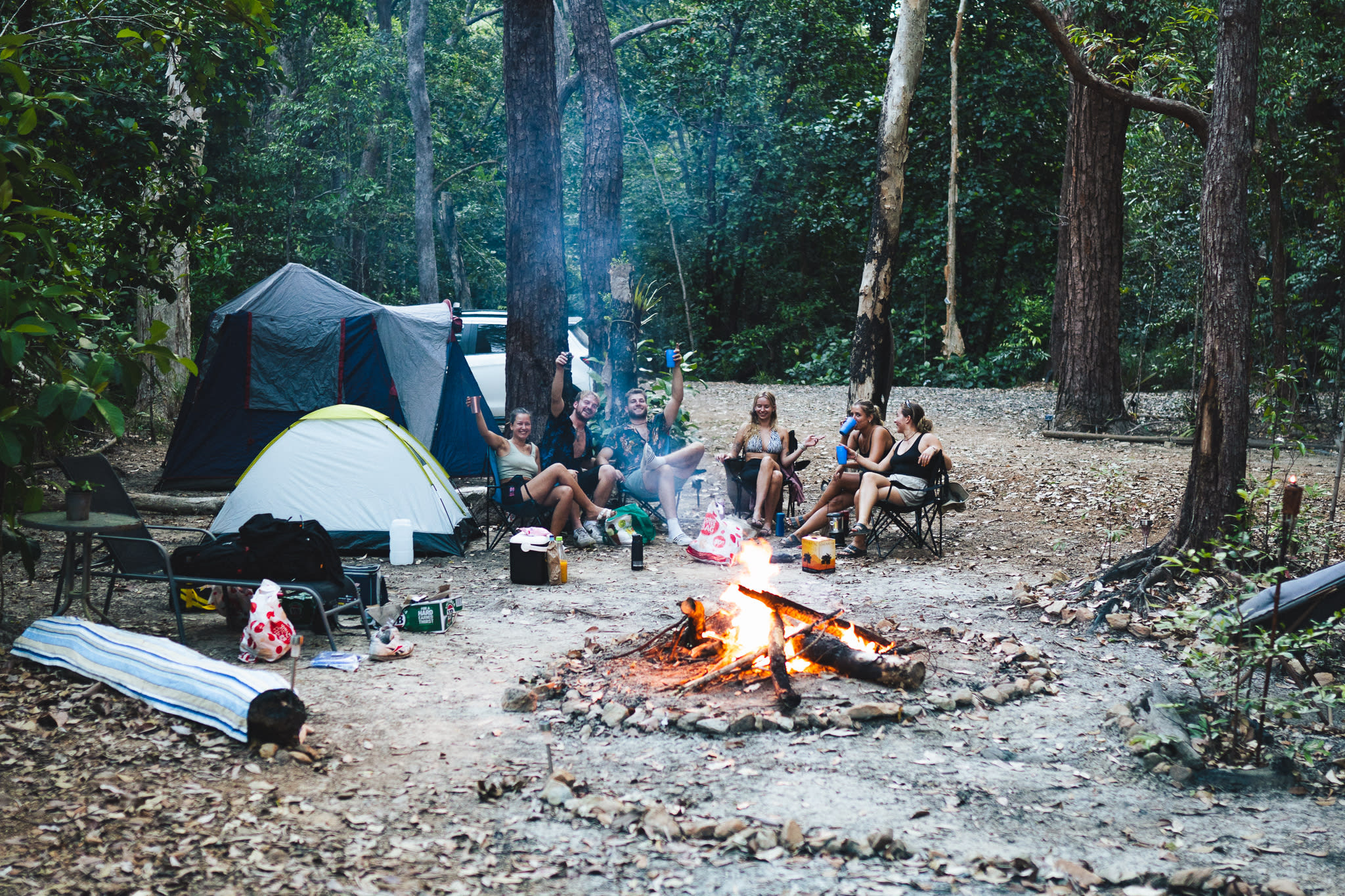 Campers having a jolly time around the fire