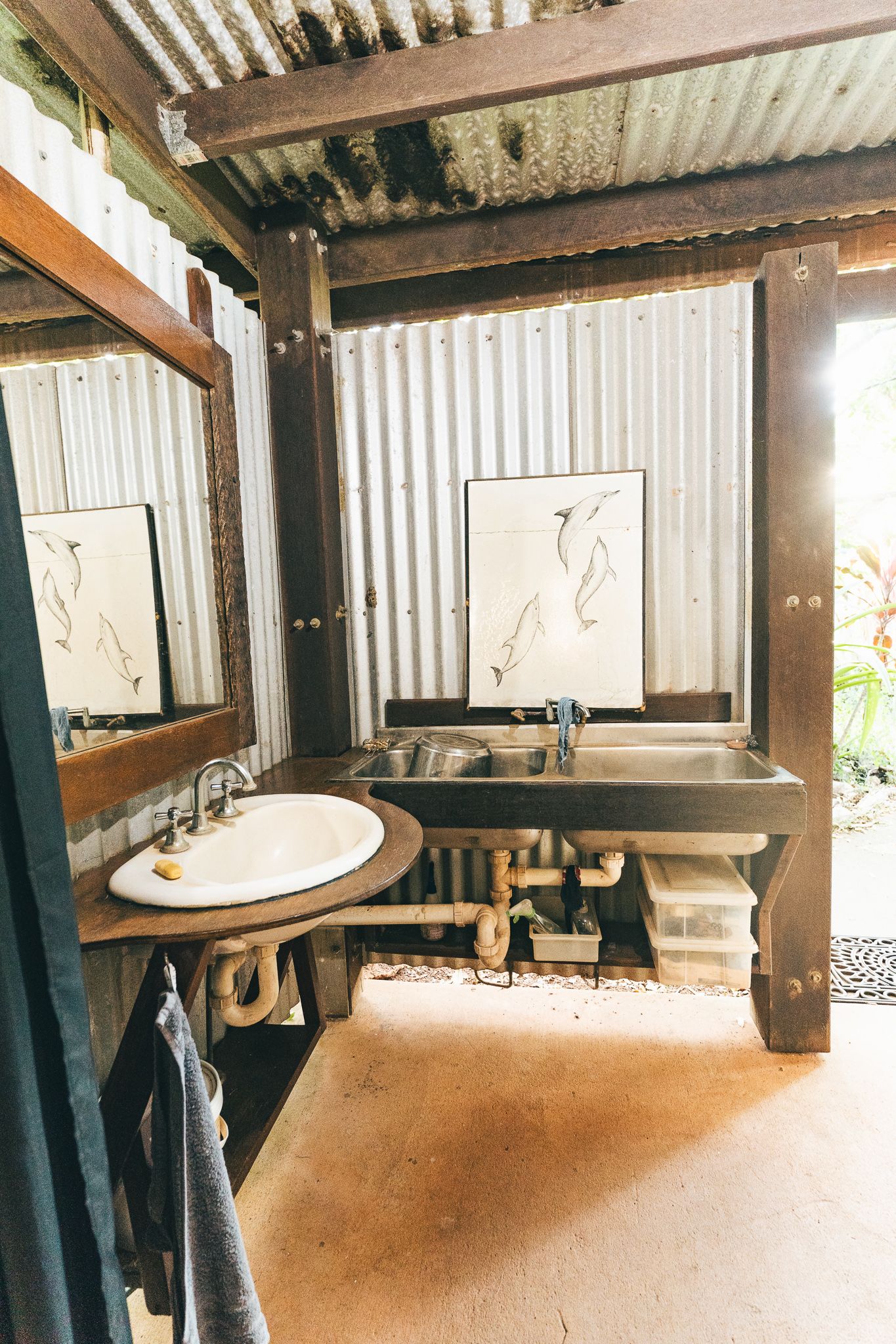 Vanity with sink and mirror outside the showers