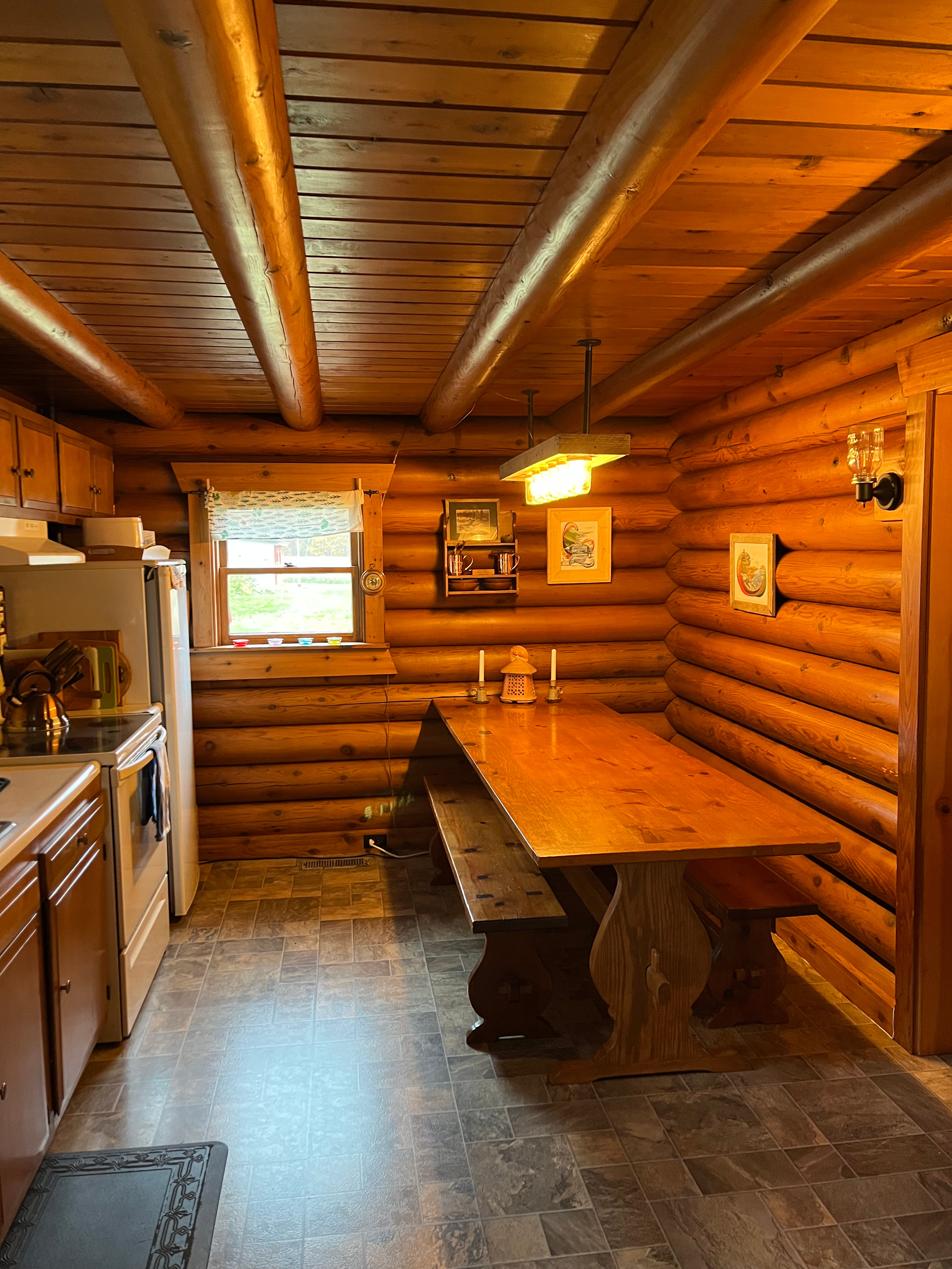Kitchen and dining room complete with table crafted from a pine tree from the land