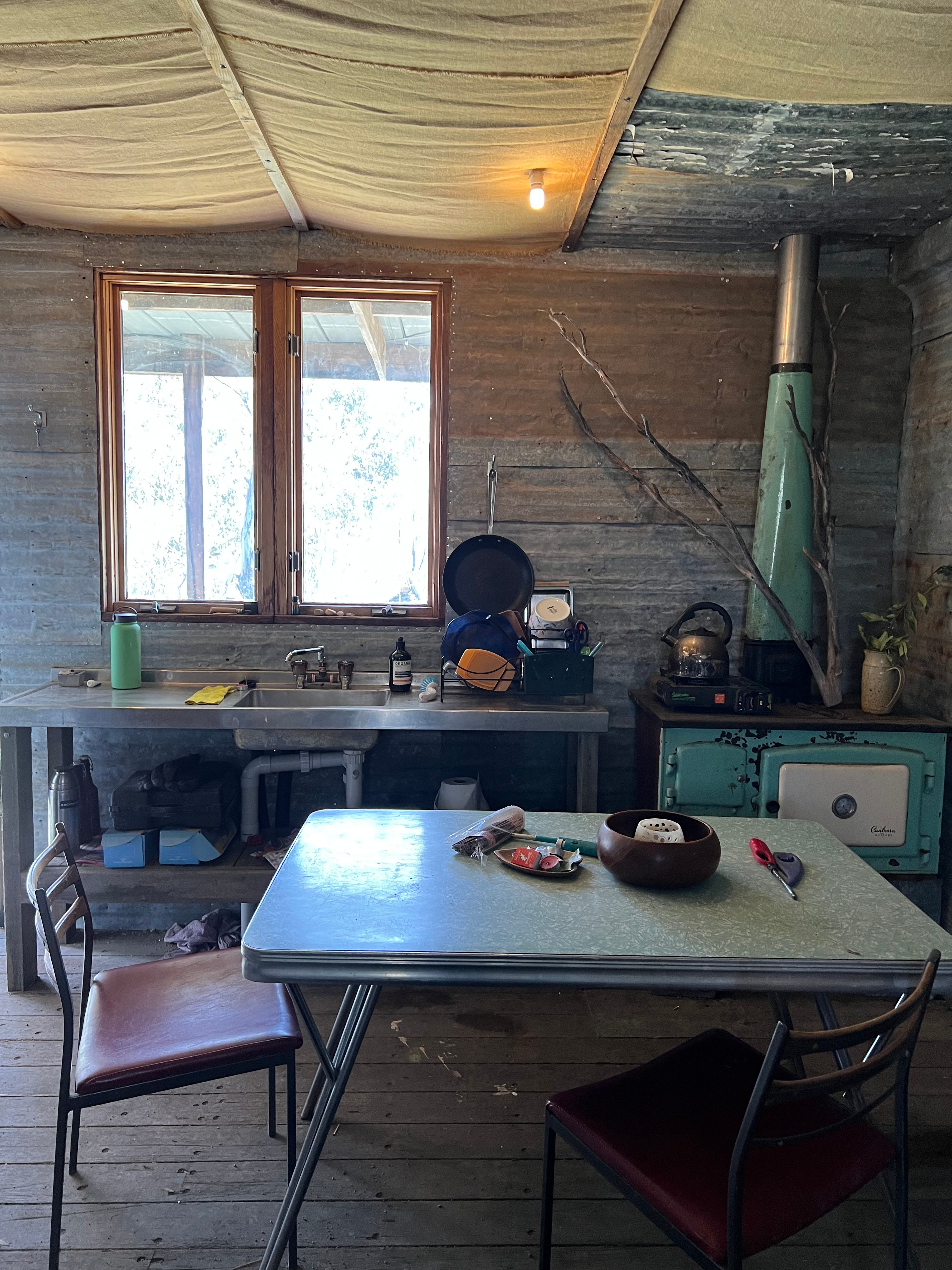 Kitchen has sink with gas hot water and wood burning stove. There is also a butane gas cooker available. 