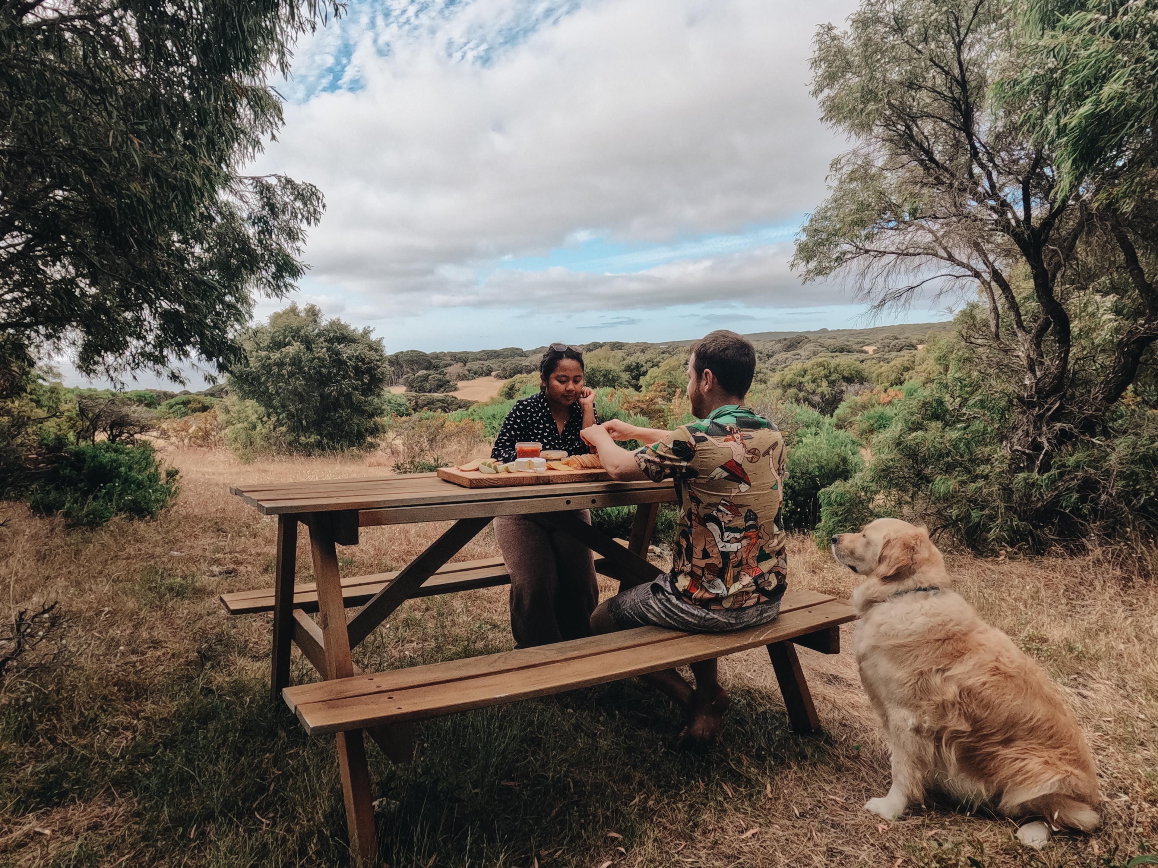 A picnic table next to the cabin