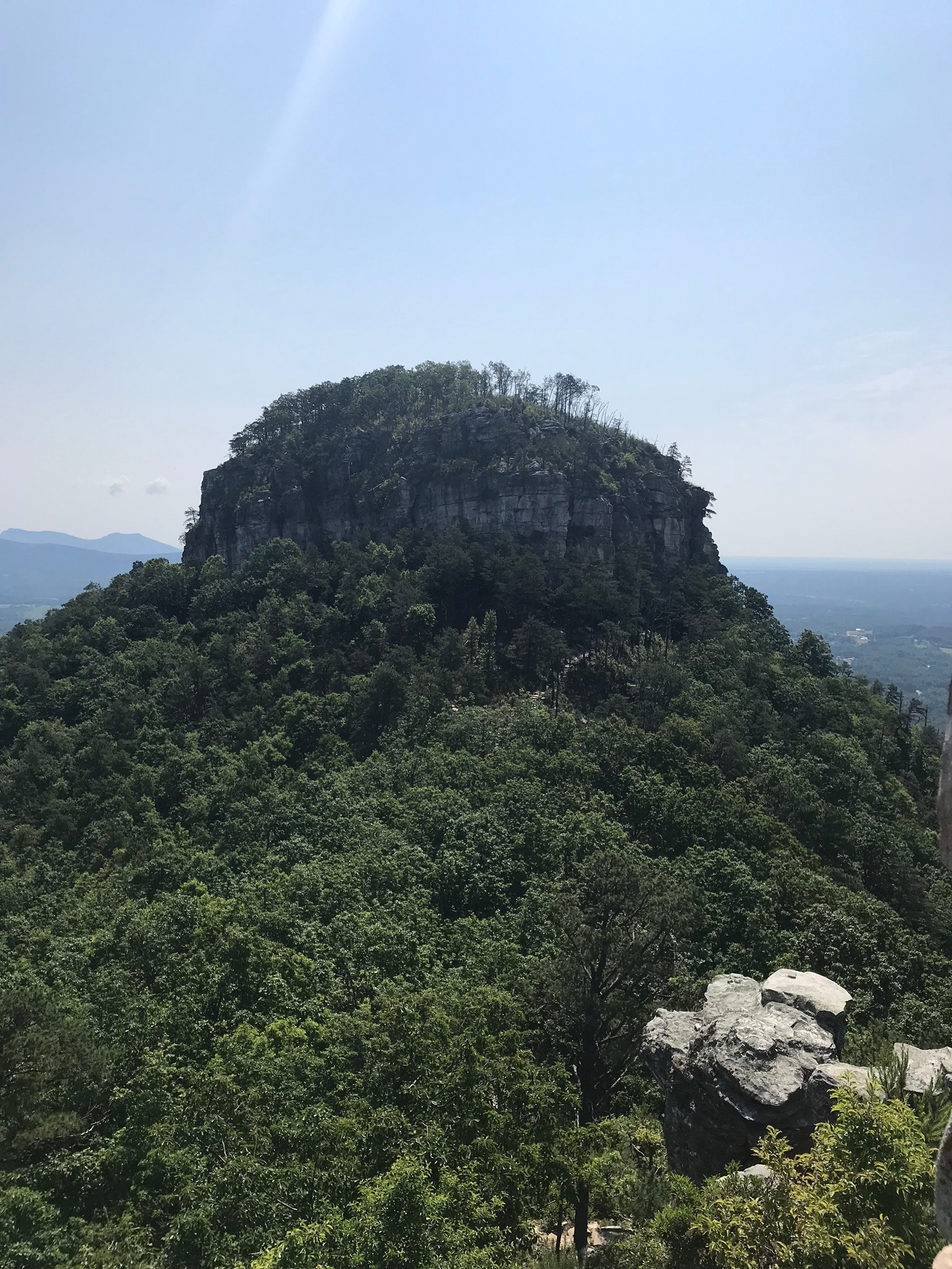 Drive up to Pilot Mountain State Park, to parking area close to top, to access trails from beginner to difficult.