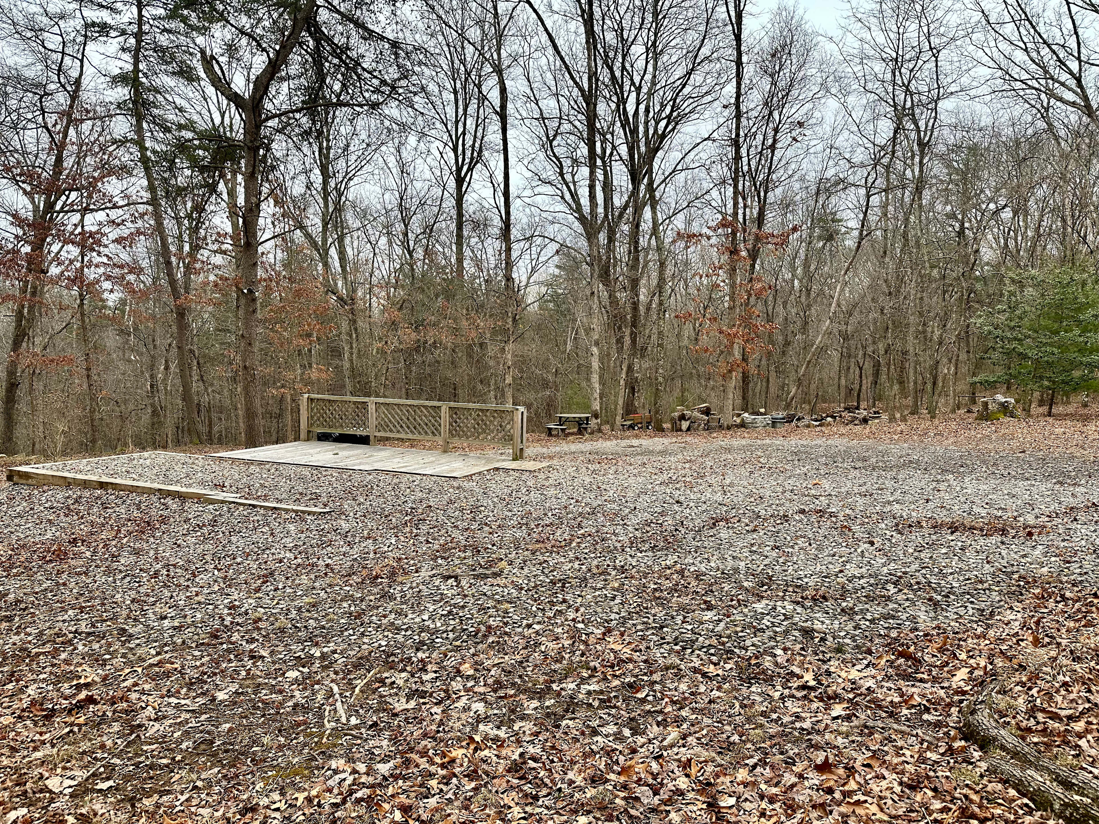 Gravel RV pad w/WiFi, full hookups (30 amp electric, septic, city water), trash bins, picnic table, fire pit, deck, and 8 acres to explore