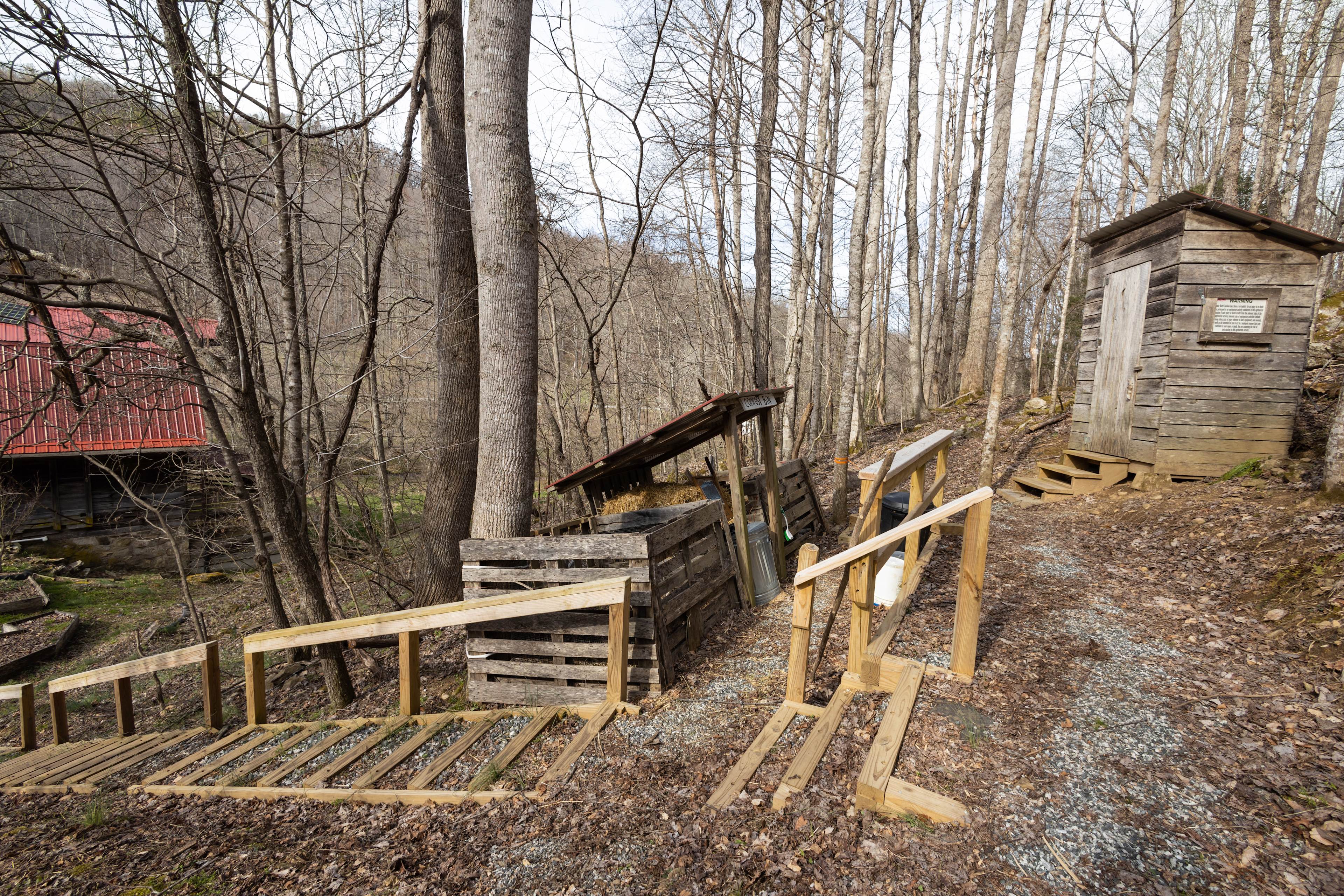 Outhouse and compost area, with stairs leading to it.