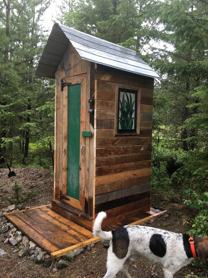 The well-appointed outhouse includes a collection of old New Yorker magazines and a stained glass window to help you enjoy the process!