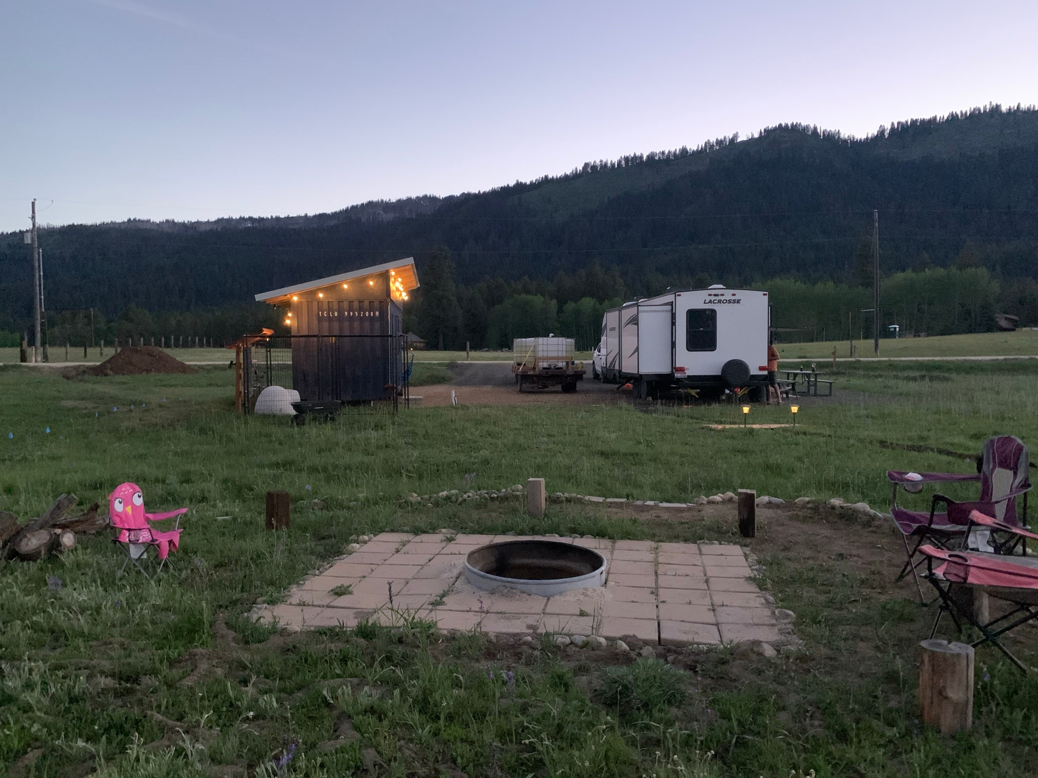 Open site. Shipping container shed is not accessible to guests. RV is not included in booking. A porta potty will be on-site when the season opens.