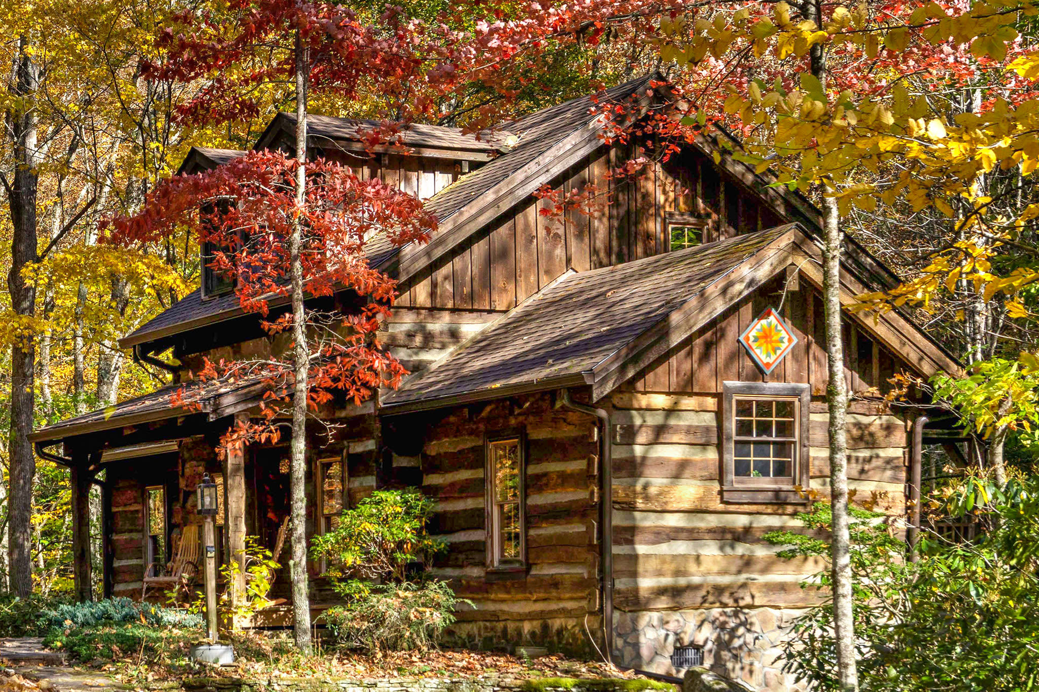 Comfy, cozy real log cabin! Secluded yet accessible off a state road with flat driveway, this log cabin is in a magical setting