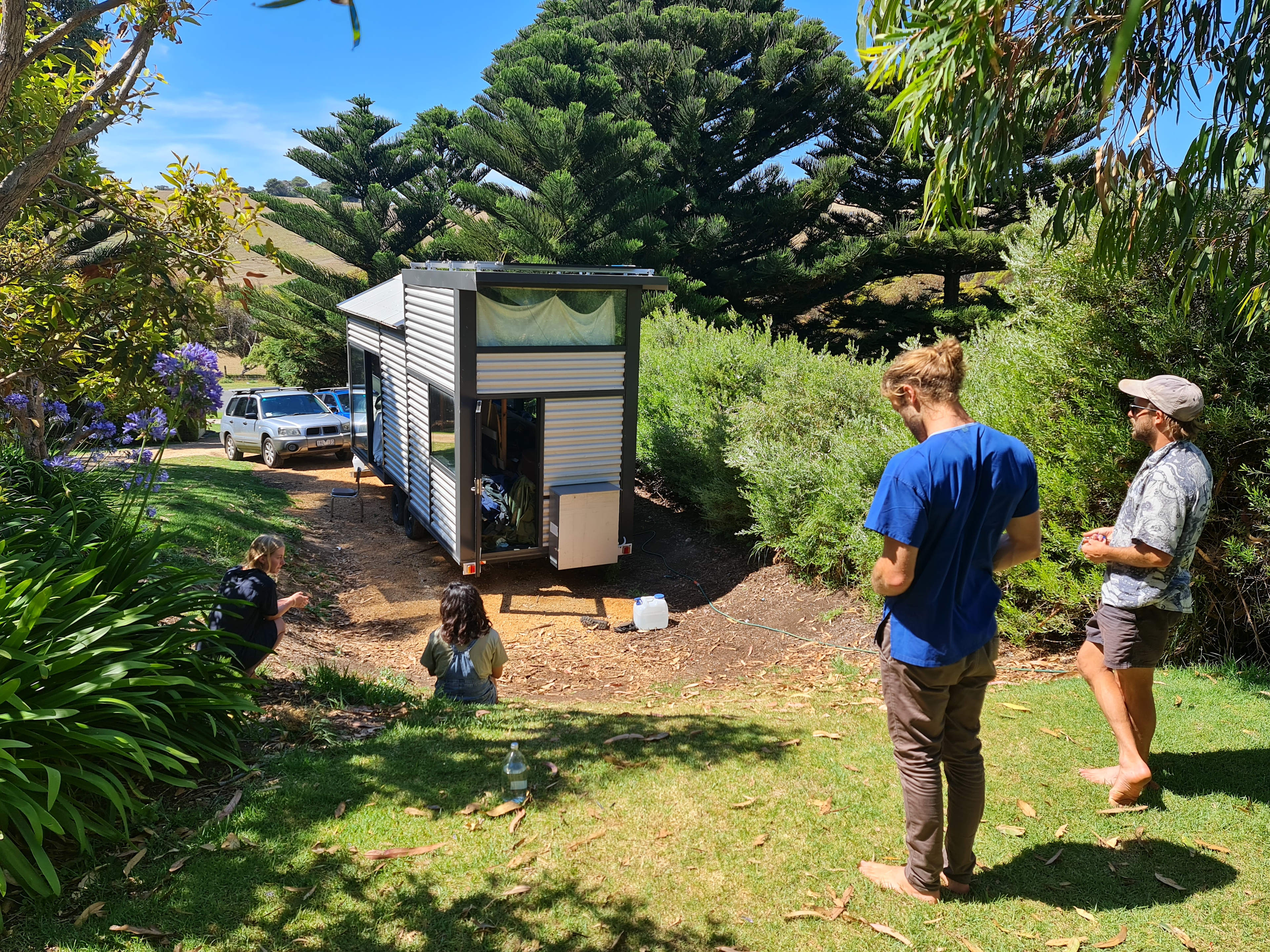 From flat grassy area, tiny home down below.