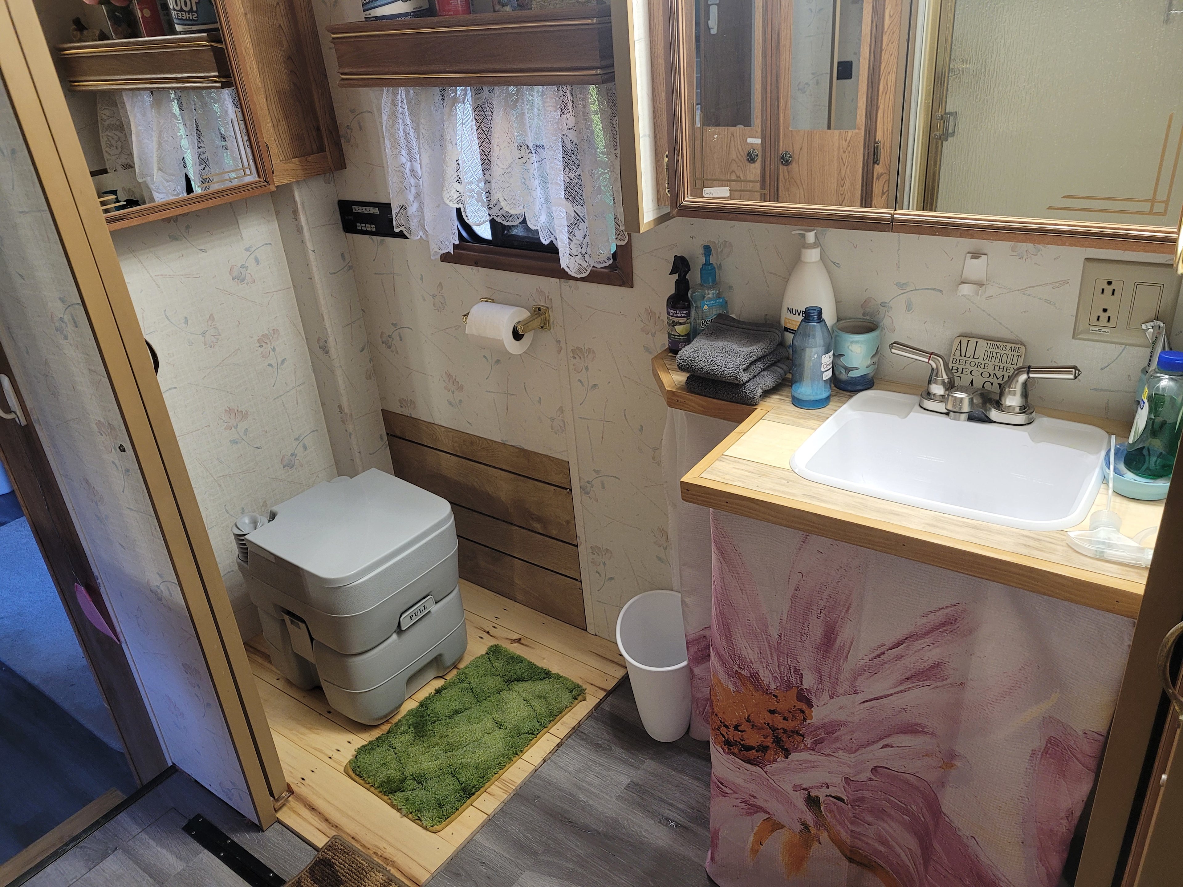 The bathroom.  The porta potty has up to 50 flushes.  The directions are posted beside it.   There's a spacious shower with soap, bodywash,  shampoo, and conditioner.   It's a camper so hot water is limited.  are provided.  There's also a fully maintained porta potty outside.
 