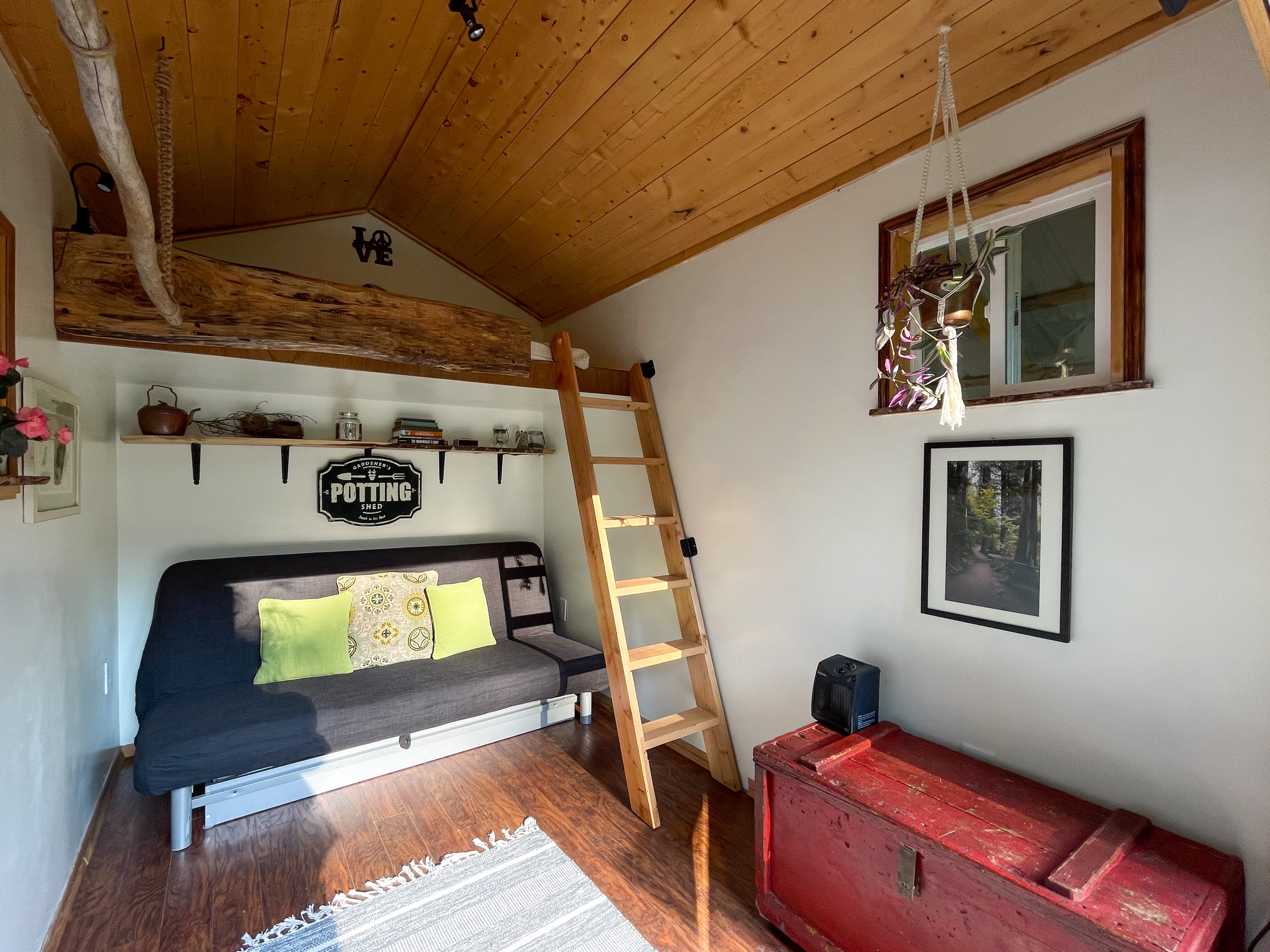 Foldout futon (sleeps 2) with linens underneath. Ladder to the loft bed (sleeps 1). 