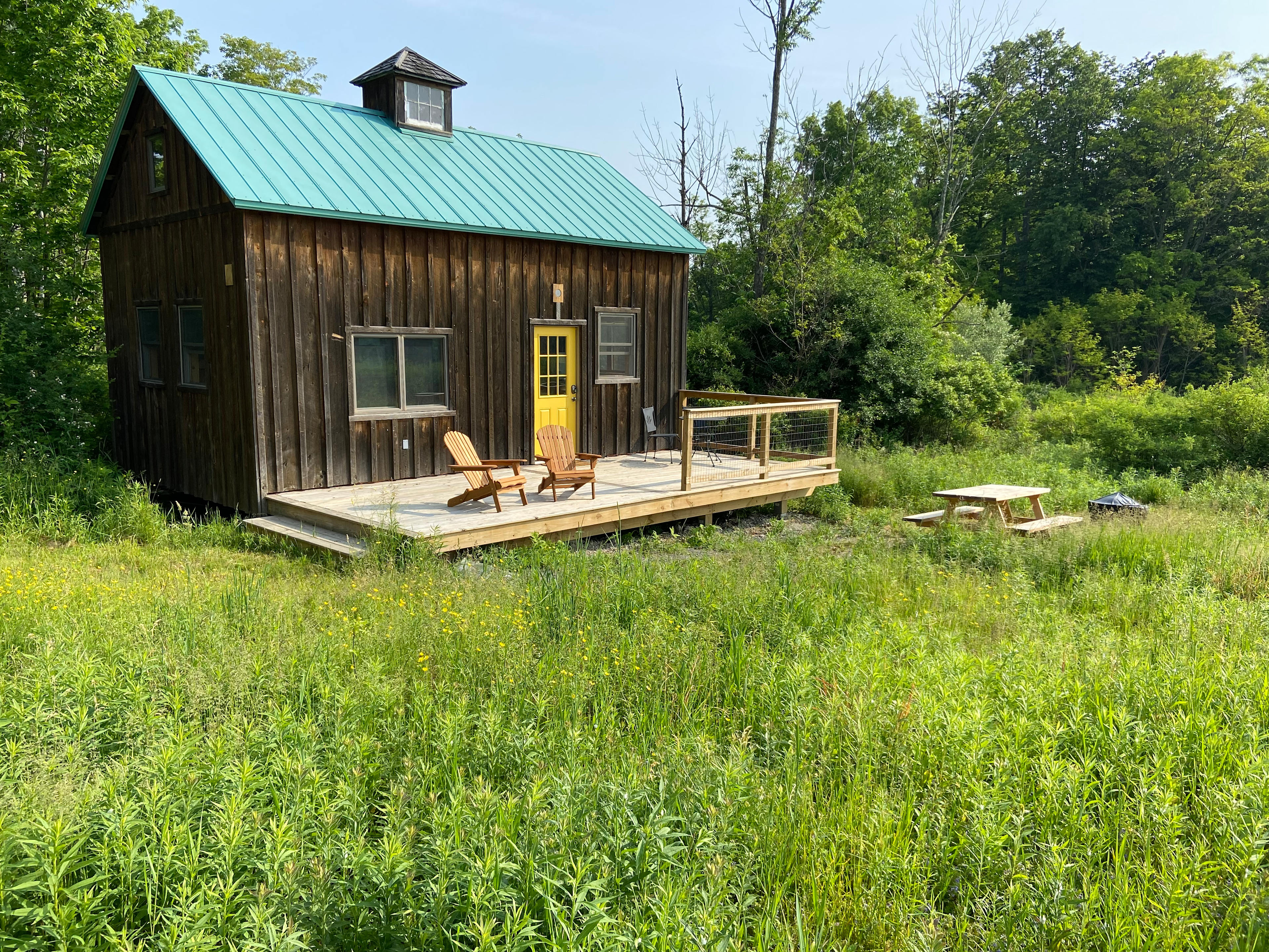You will be surrounded by a land trust meadow that rolls up to an old growth maple forest with accessible public hiking trails.