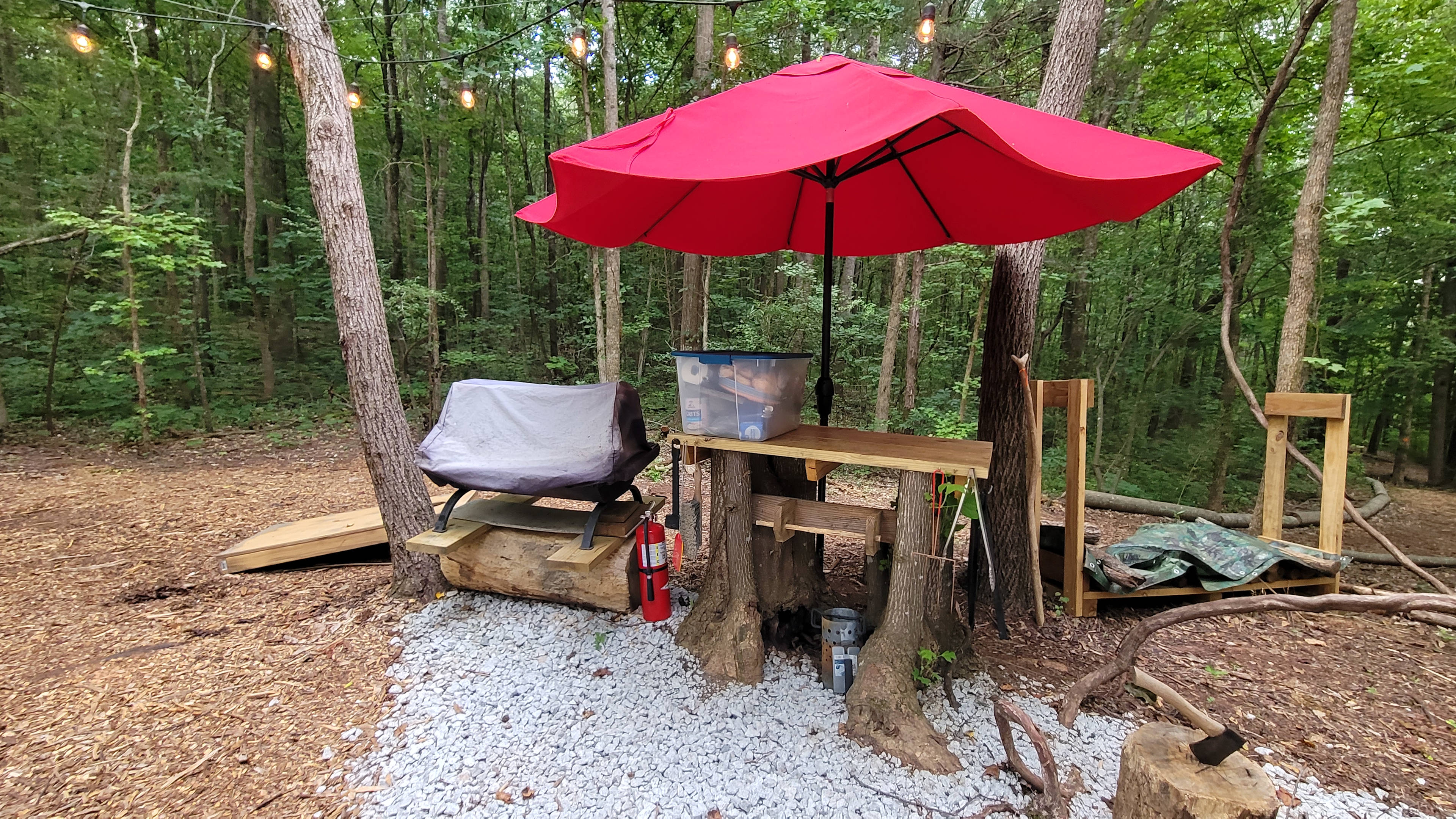 Umbrella protected food from rain. They also have a charcoal grill and some cooking utensils 