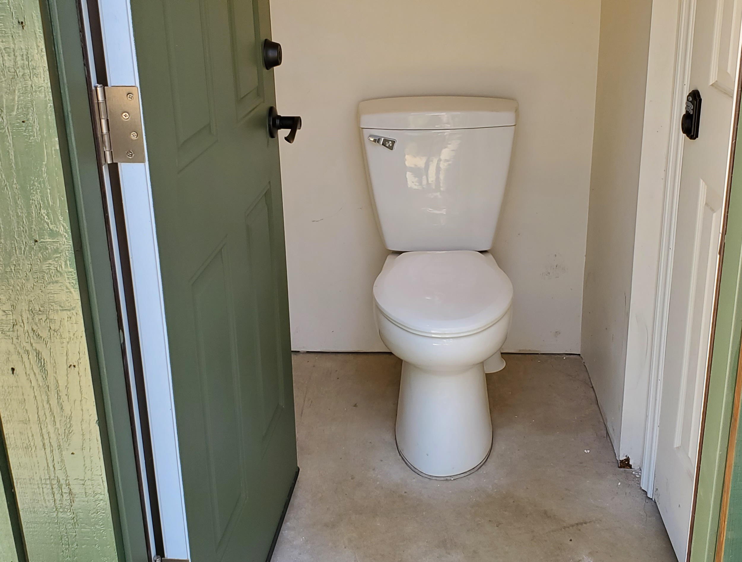 Toilet facility on the front of our shop building. 120 steps from the tent.