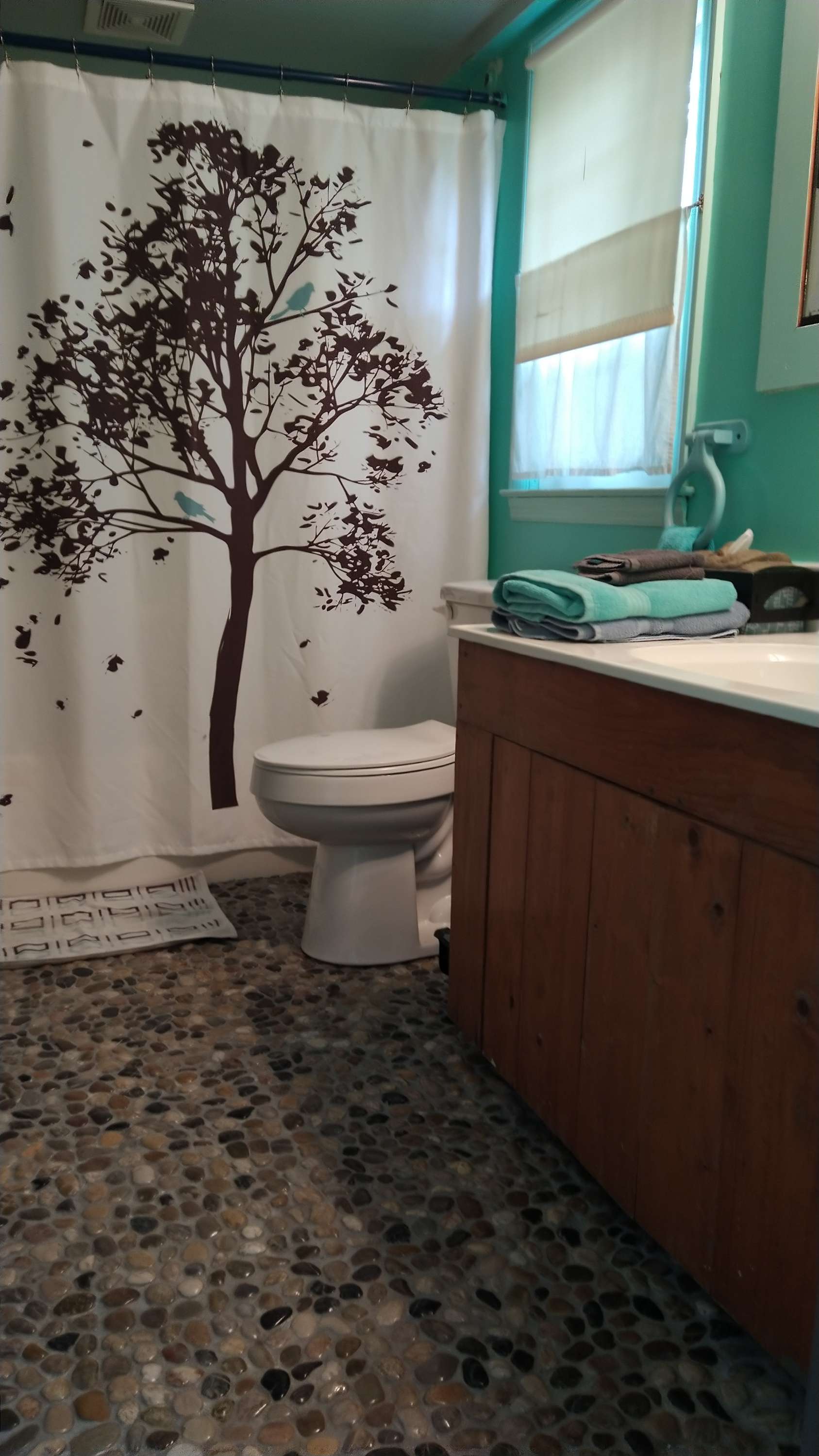 The ensuite main feature is the river rock floor to bring a dose of the outside into your 'glamping' stay. The tub has shower wand. (Please do not wash your dogs inside. Just ask and you can use the outside hose).