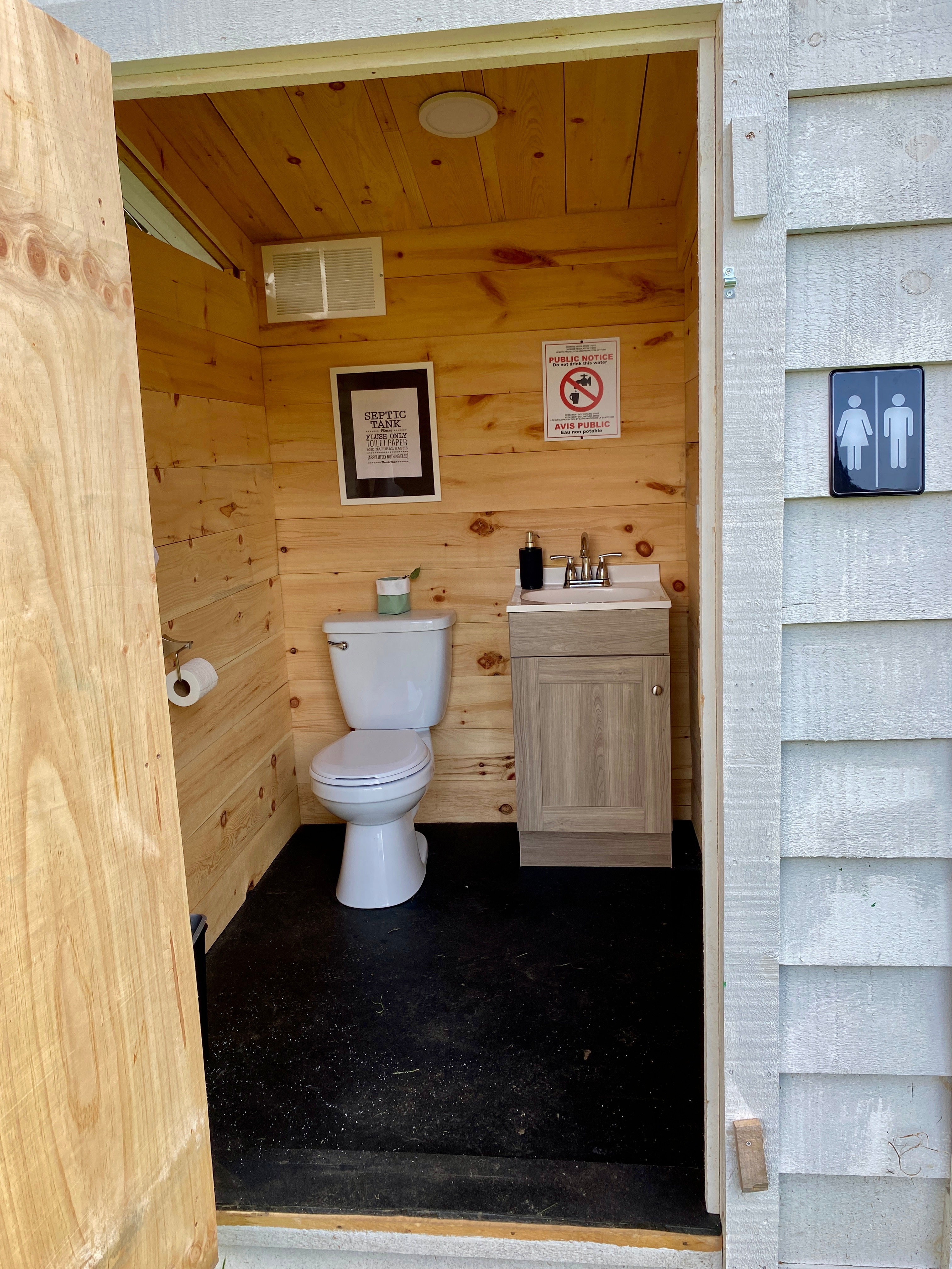 Clean washrooms with motion activated lighting for nighttime! Outdoor shower is around the back.
110volt supply on side of washrooms near fire pit.