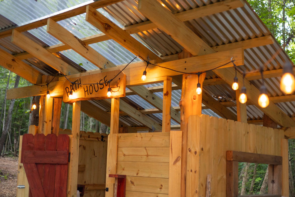 Private bathhouse with hot shower and flush toilet