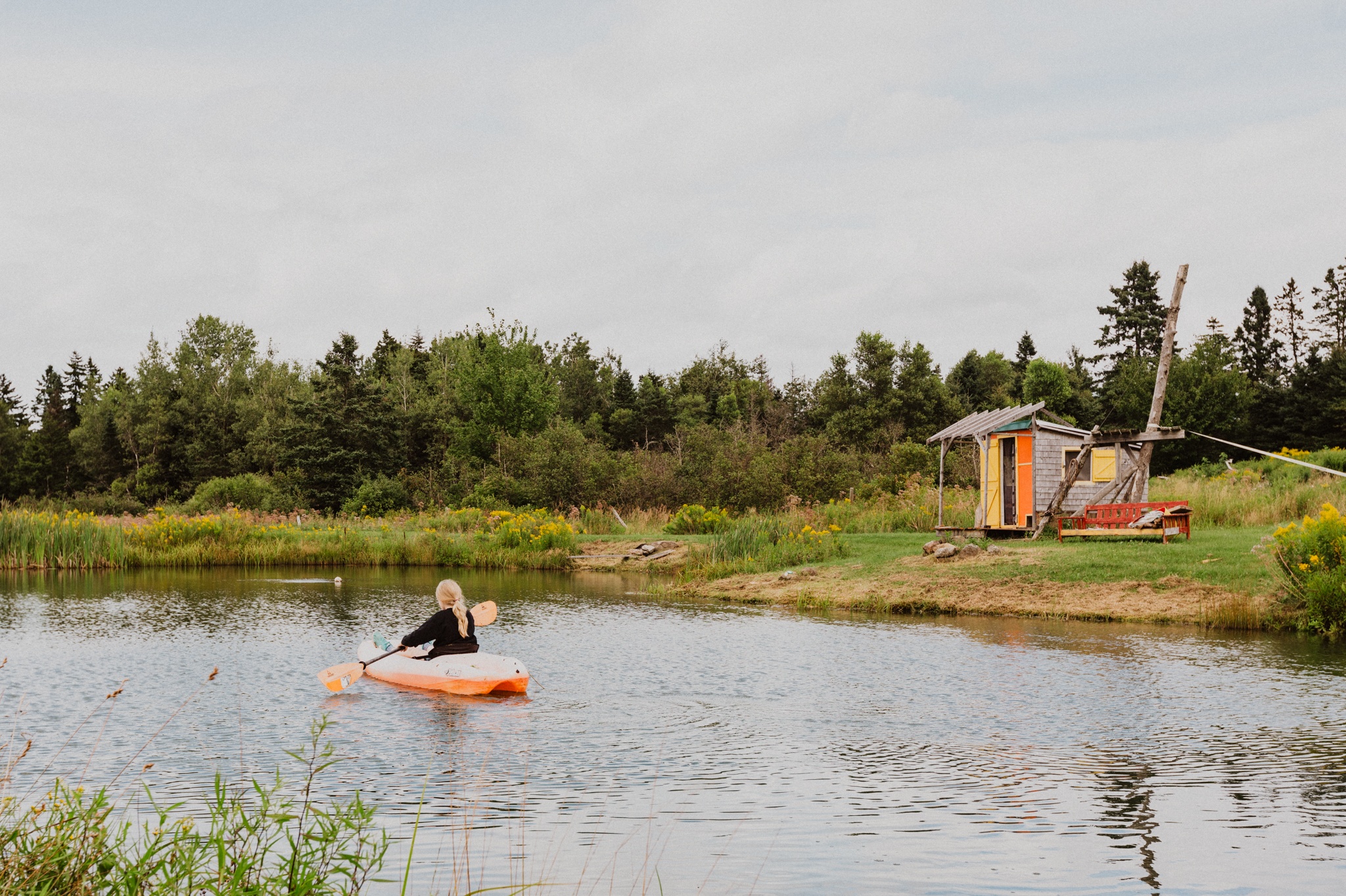 On the property is a cabana with seating, but also a small kayak for paddling around a pond. 