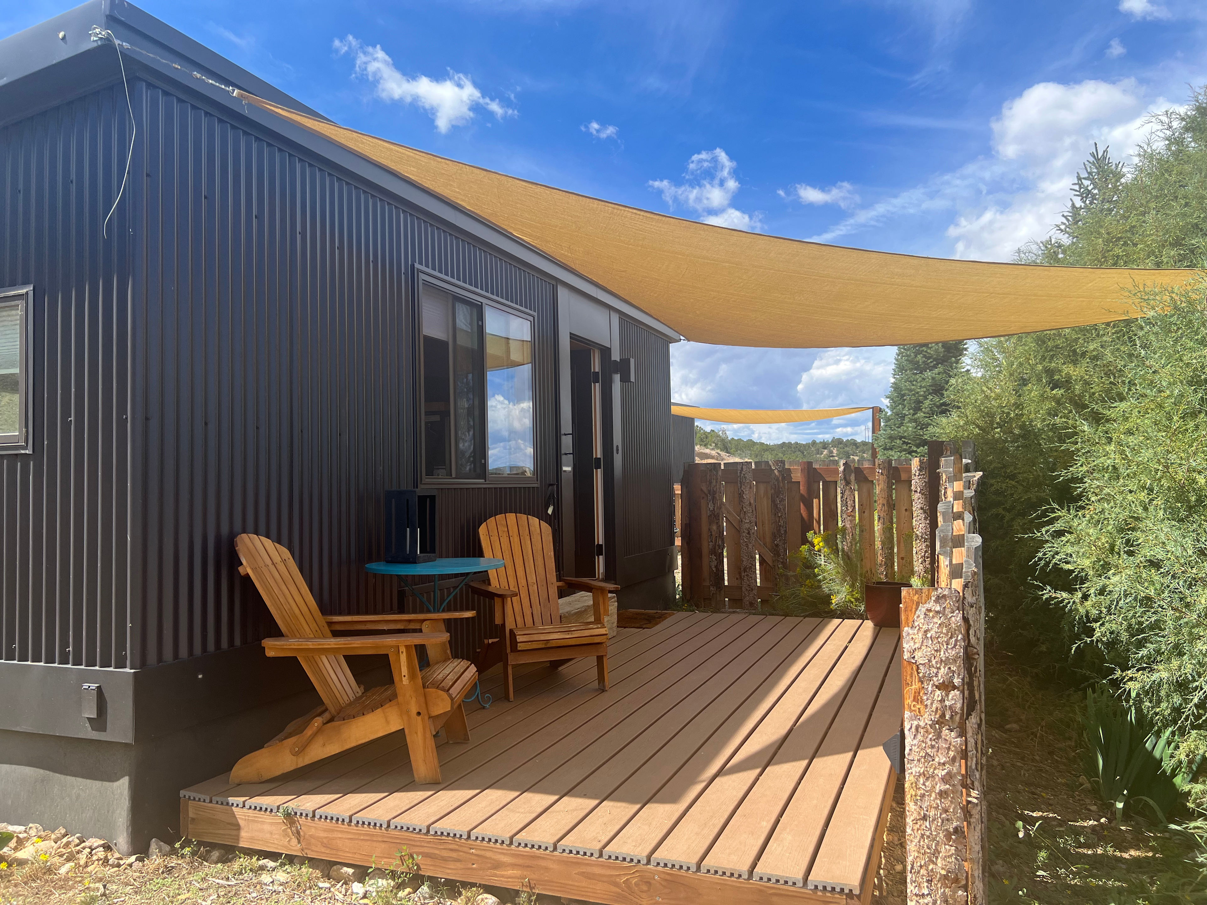 A welcoming scene on the tiny house porch, nice and private from the other sites