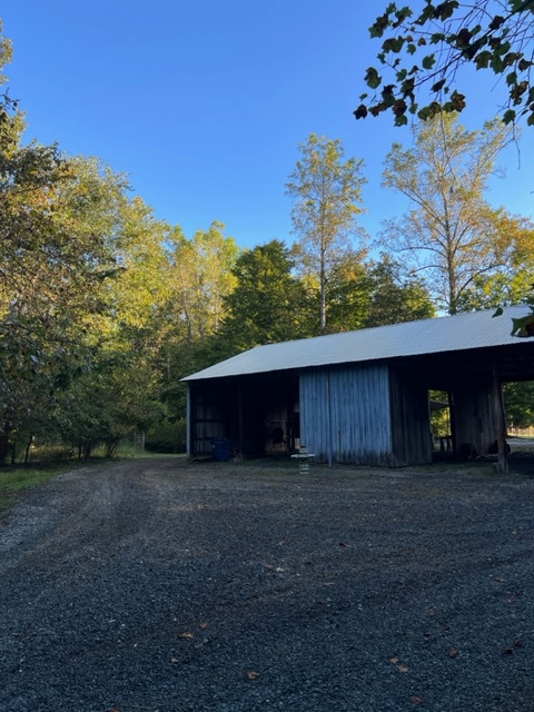 Vintage pole barn which you could hypothetically park under but it is away from the shore power. 