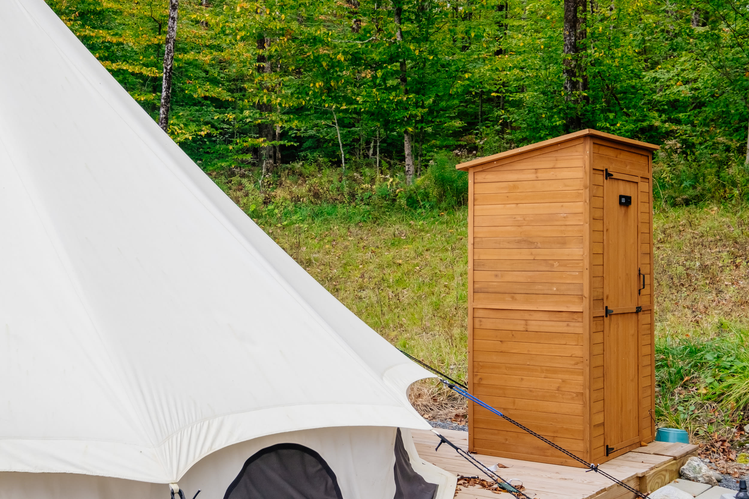 Privy behind tent