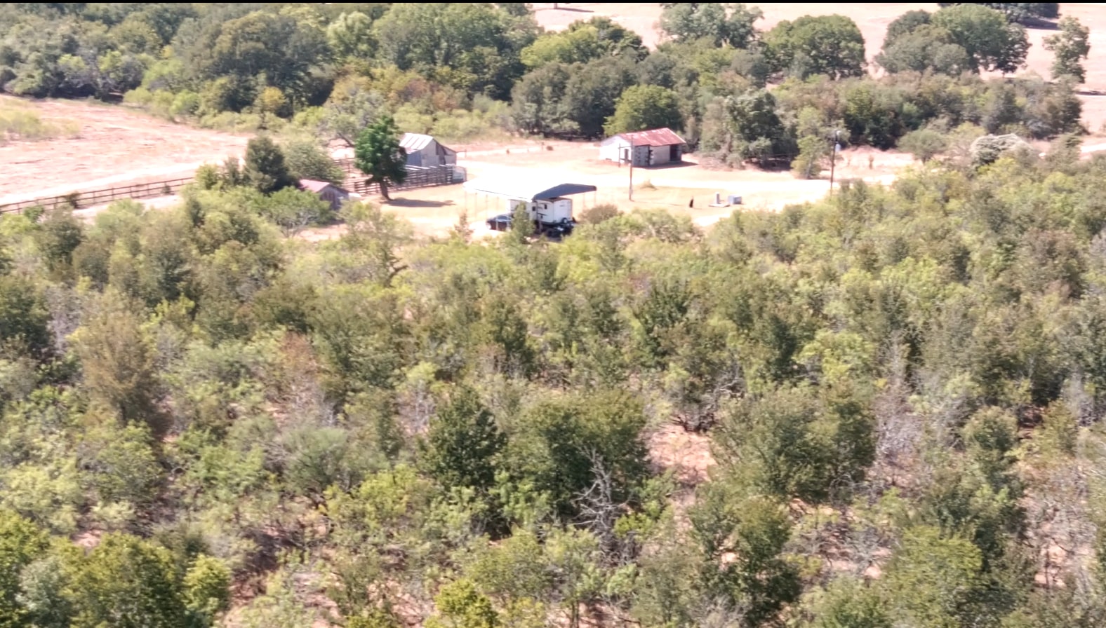 Aerial view from woods to barnyard with facilities.