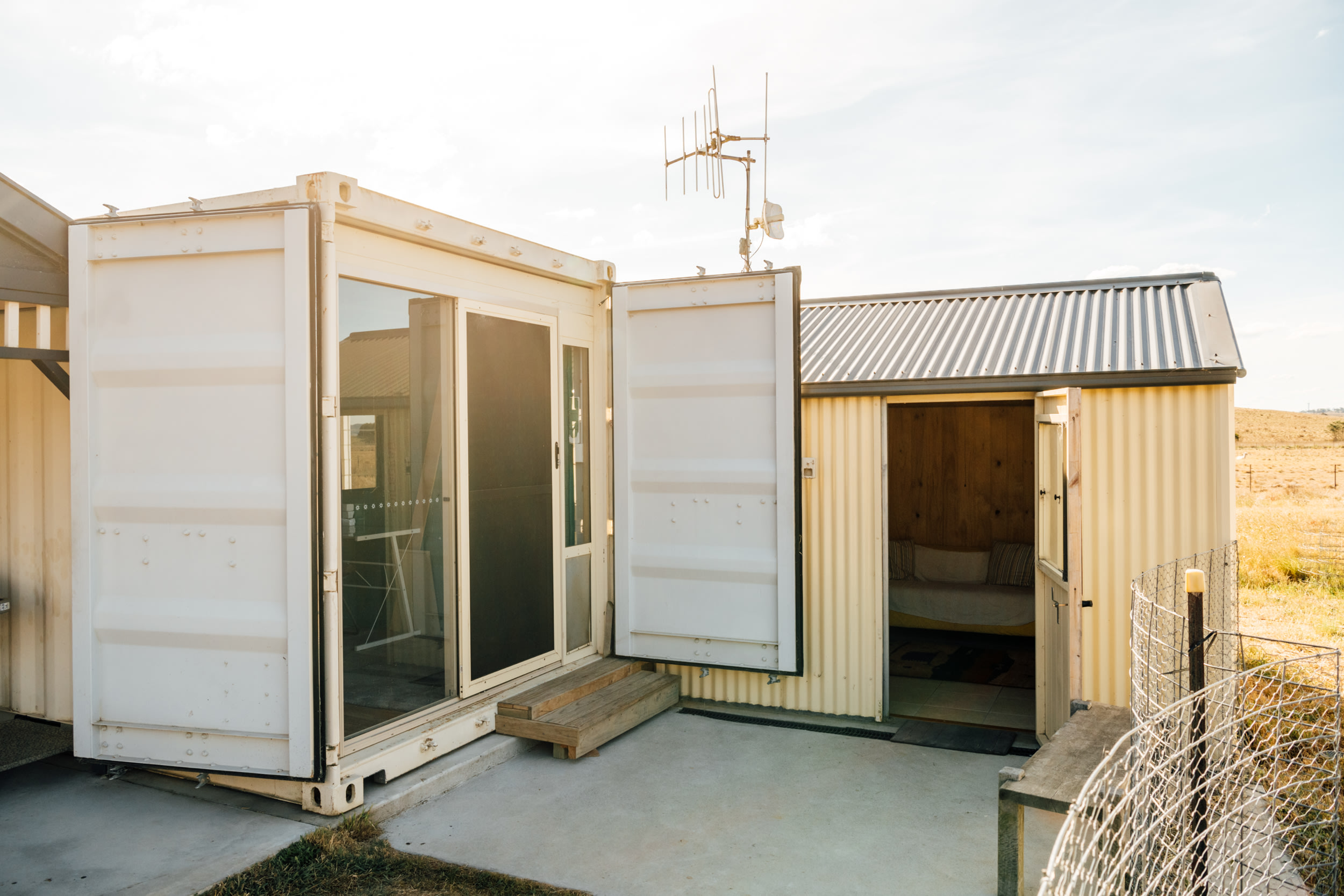 Entrance to the shipping container listing on the left and the kitchen room to the right. 