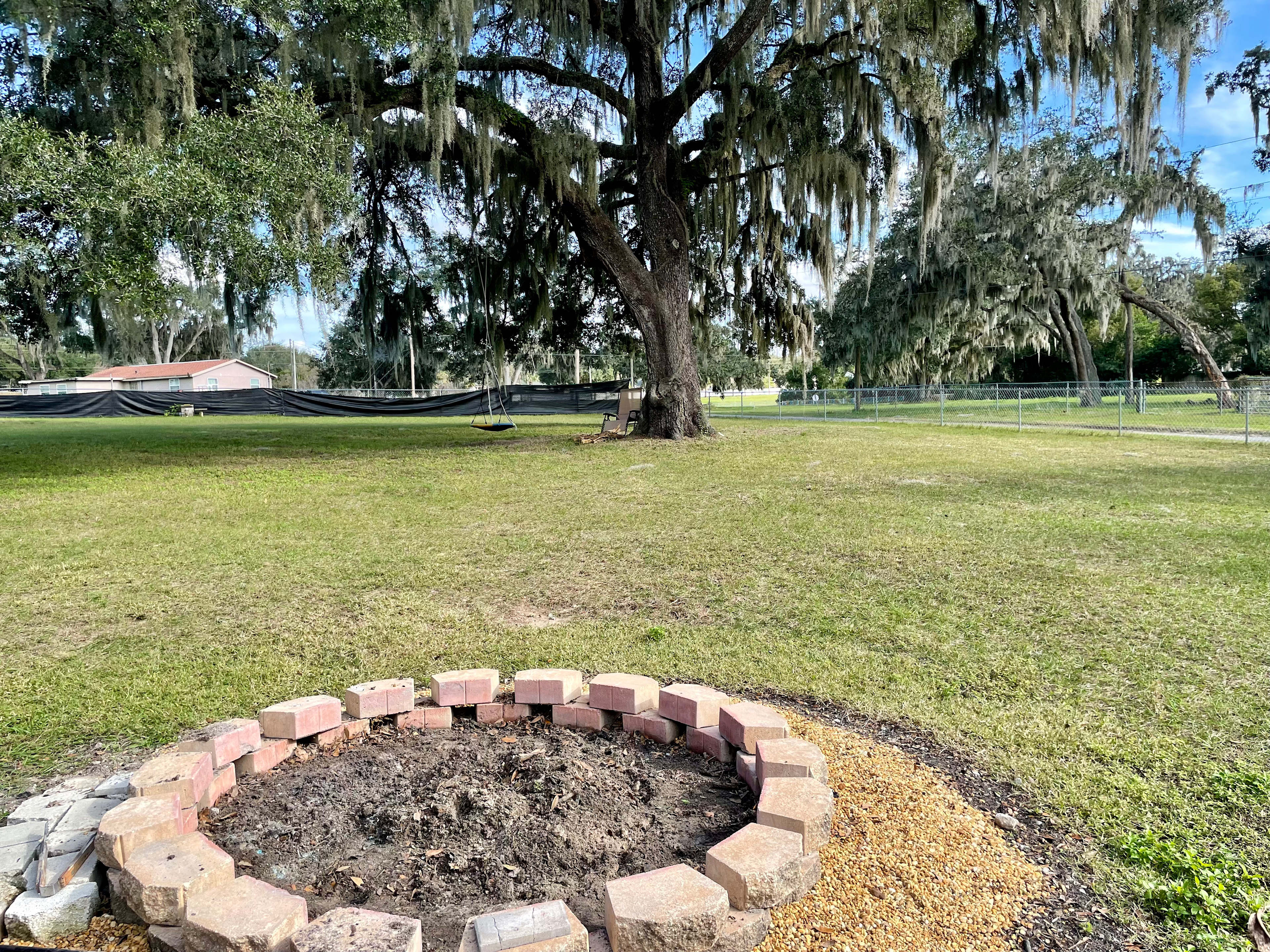 Gather around a splendid bonfire amidst ancient oak tree