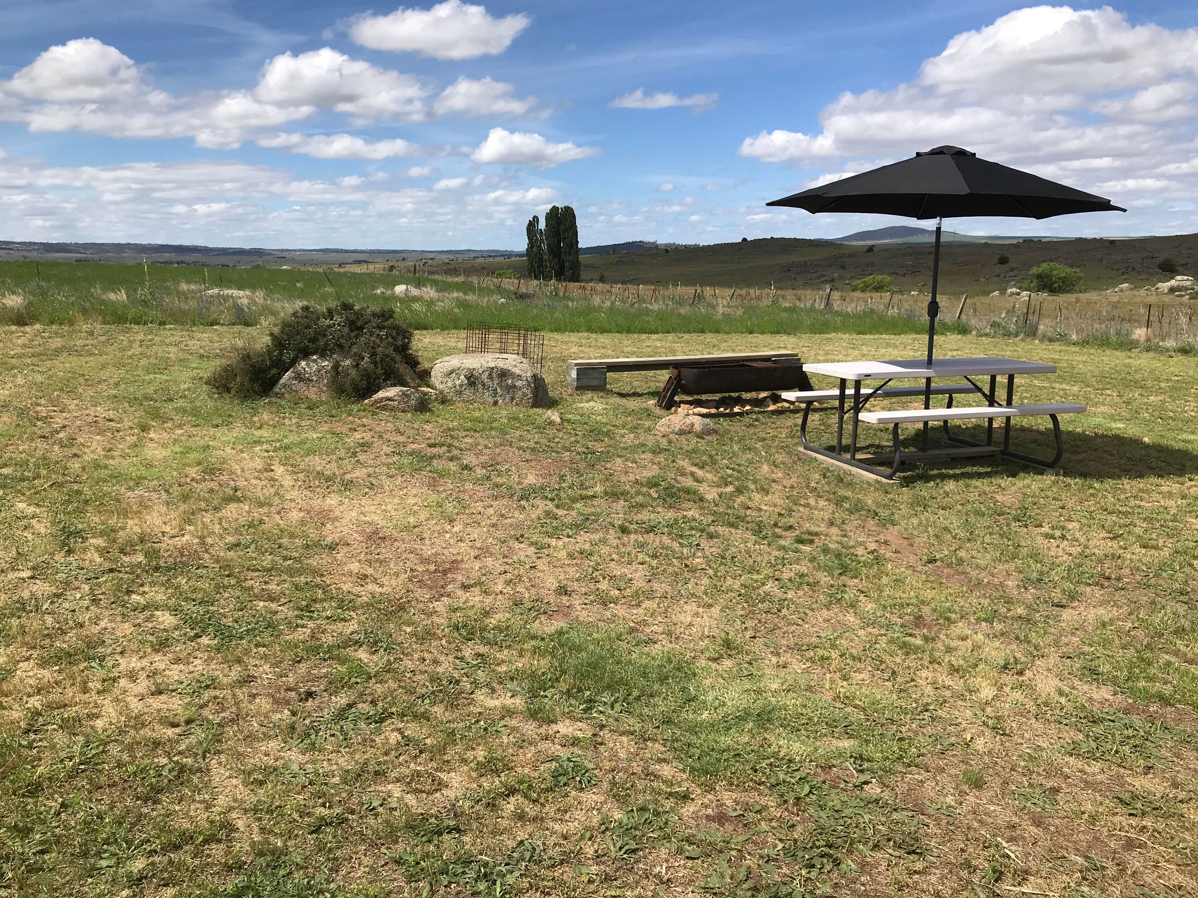 Table for 6 with umbrella, fire pit and bench seat for 5 at Granite Glen!