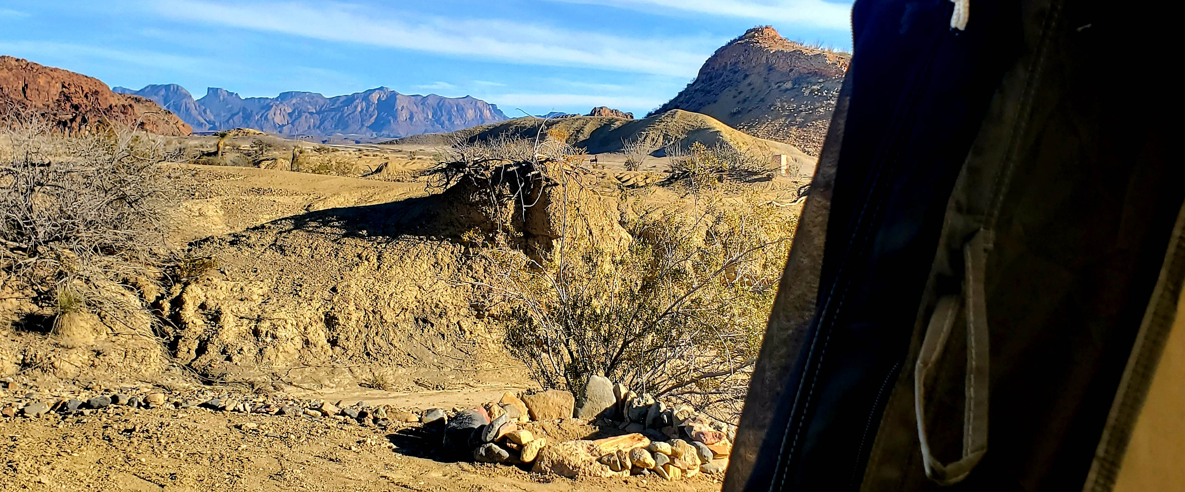 You'll be perched on the edge (but a safe distance!) of a large arroyo between you and a grand desert mountainous view