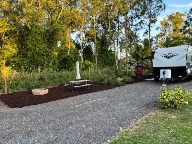 View of your RV parking area behind the Avenger RV and your campsite.