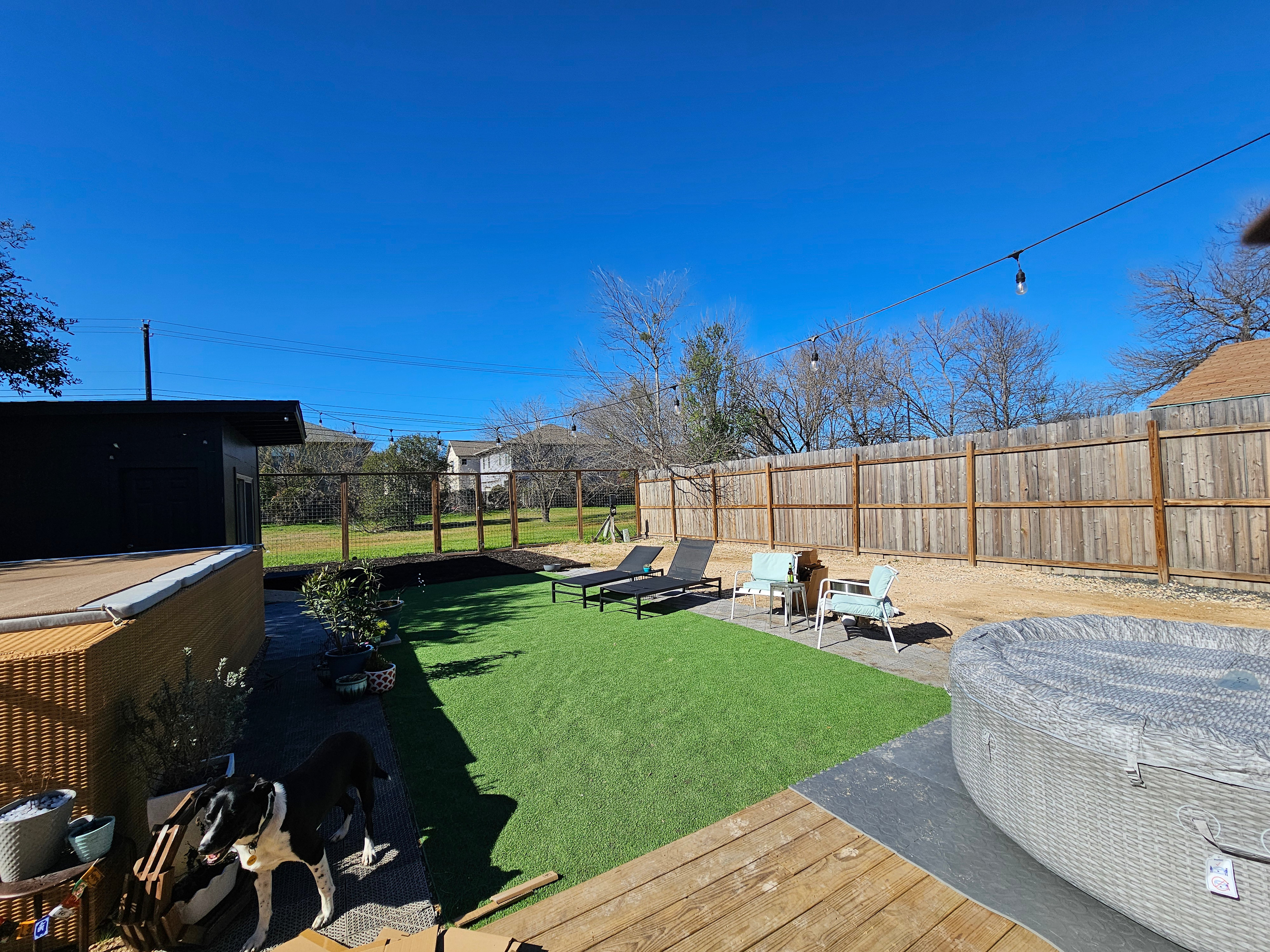 Slip on in...enjoy Austin...come to your home away from home! There's no "real" grass on the property. However, the gates in the back can be unlocked to enjoy a long and wide green space. Very large park and the river is less than a mile.