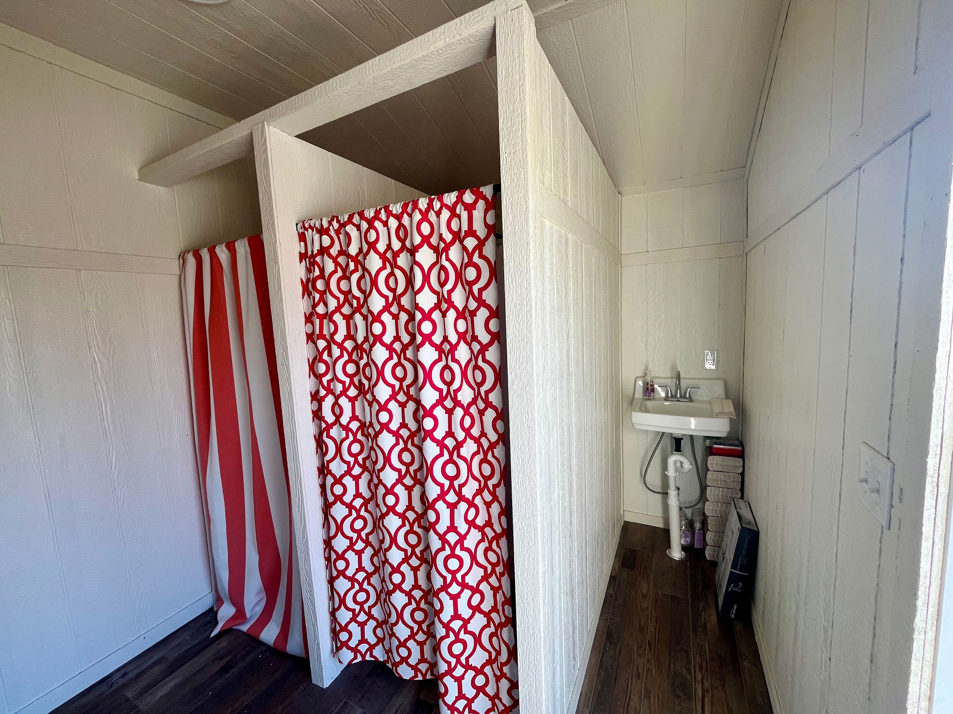 Opposite the restroom stalls are the dressing/shower stalls. You can see the sinks and electric outlets too.