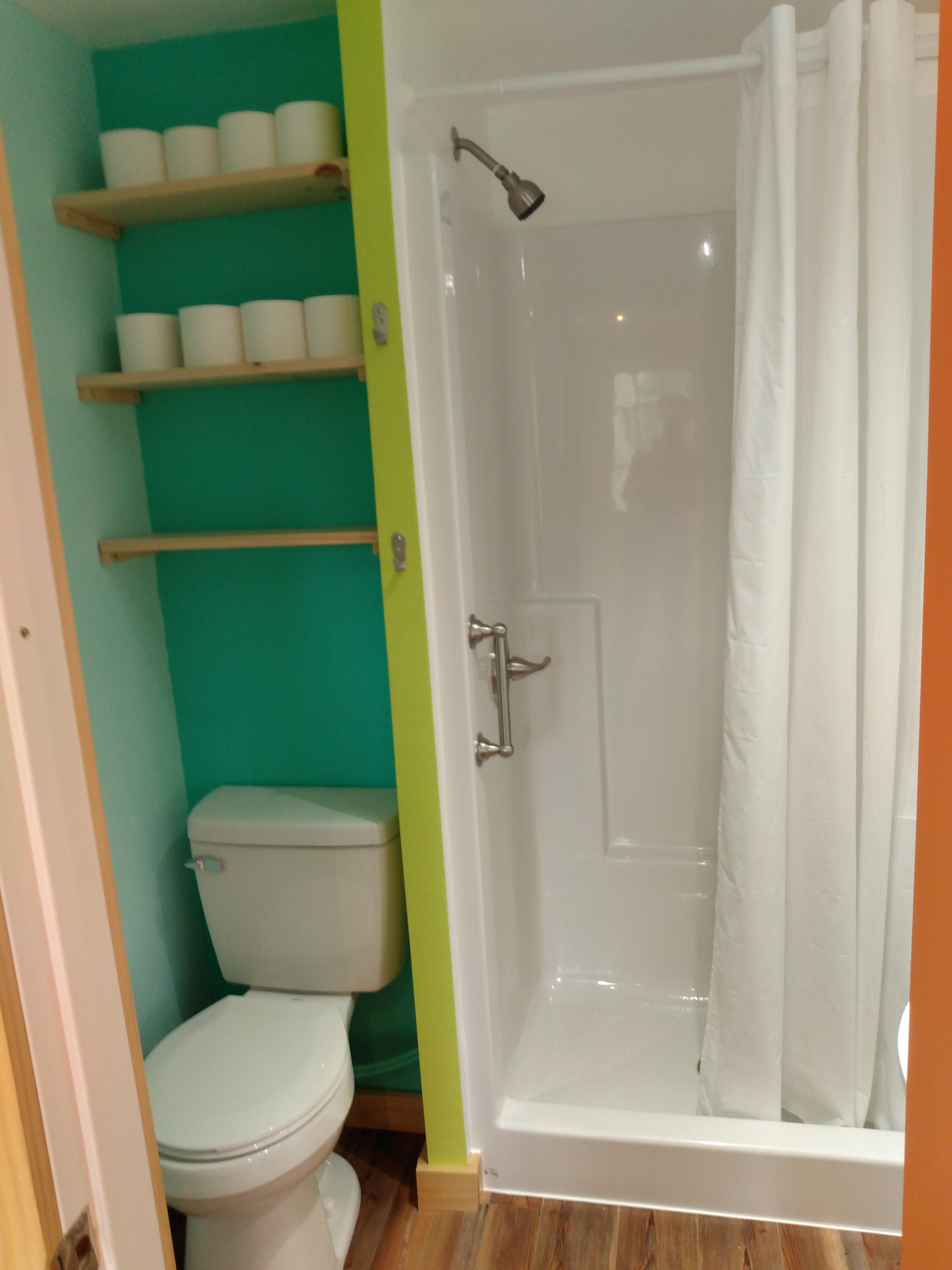 There are two bathrooms, each with a toilet and sink, and one of them has a hot water shower, shown here.