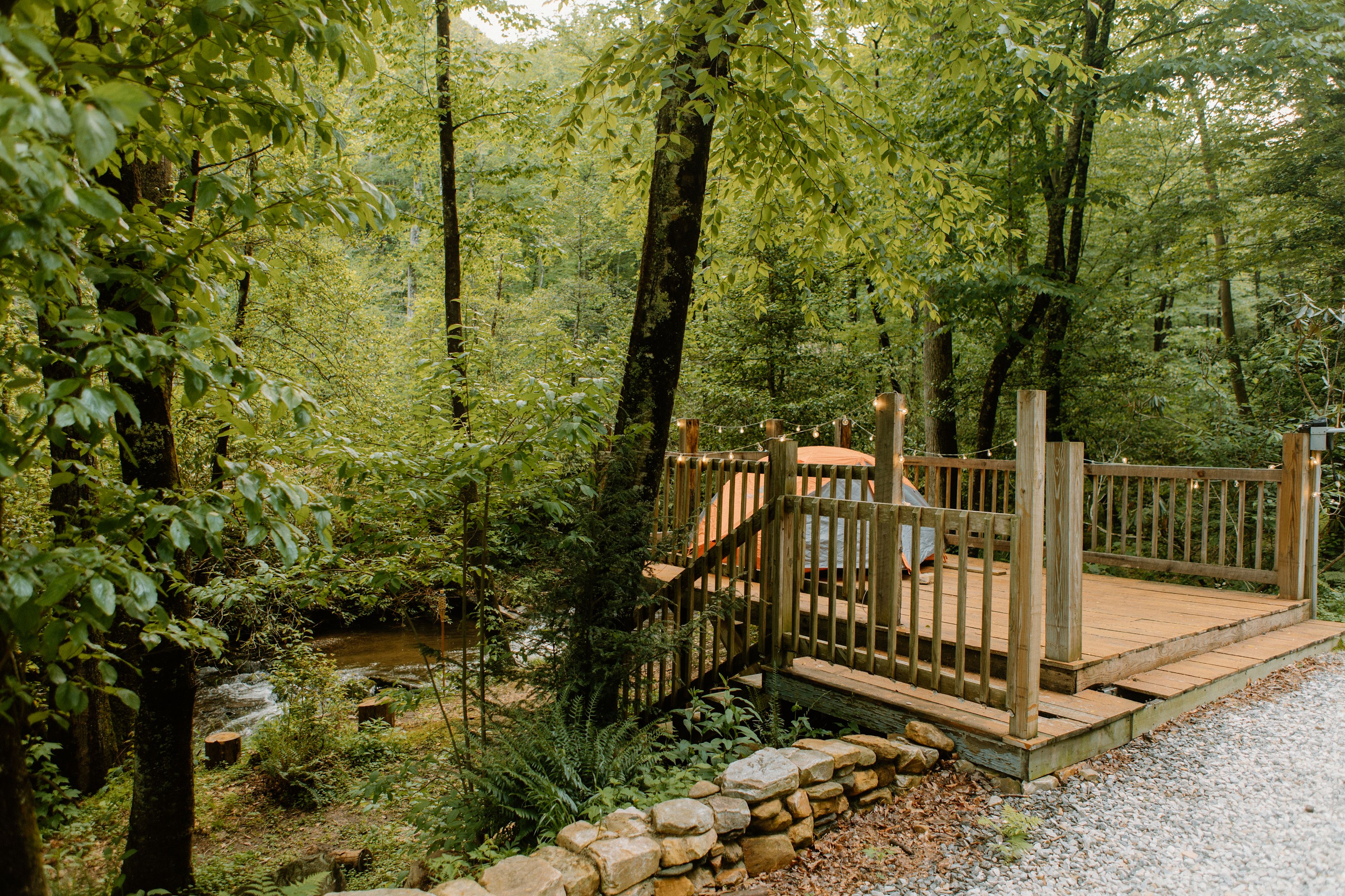tent platform with stairs leading down to creek 