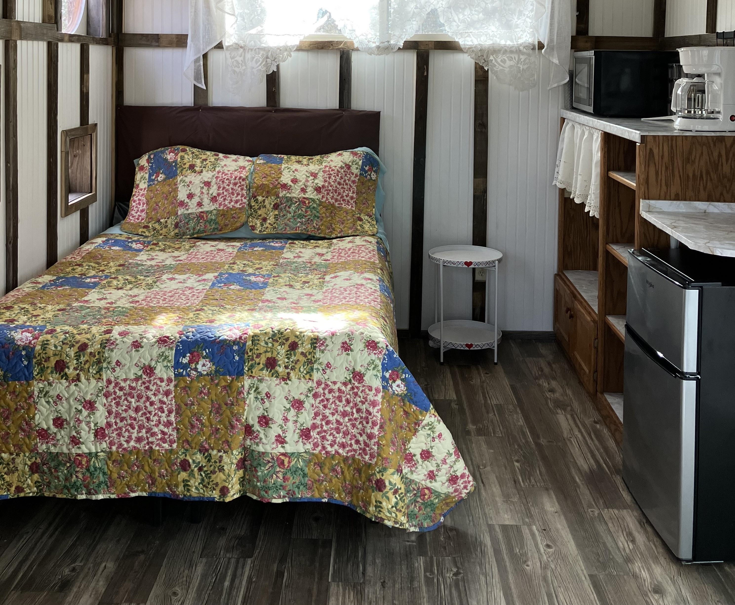 Comfortable Country Style Furnishings enhance this cozy tree house experience.  Tree House comes complete with creature comforts and amenities which include: Microwave, Mini-Fridge with Freezer, Full size Coffee Pot, Coffee, filters, creamers, sugar, salt and pepper are all provided.

Guests report that this bed is very comfortable. It has a pillow top mattress pad over a sealed mattress protector, on a new mattress.  These add comfort while also  keeping things clean and sanitary. New Pillows also have special zipped protectors underneath the pillow cases for added protection.

All is disinfected w Lysol and washed between guests visits.