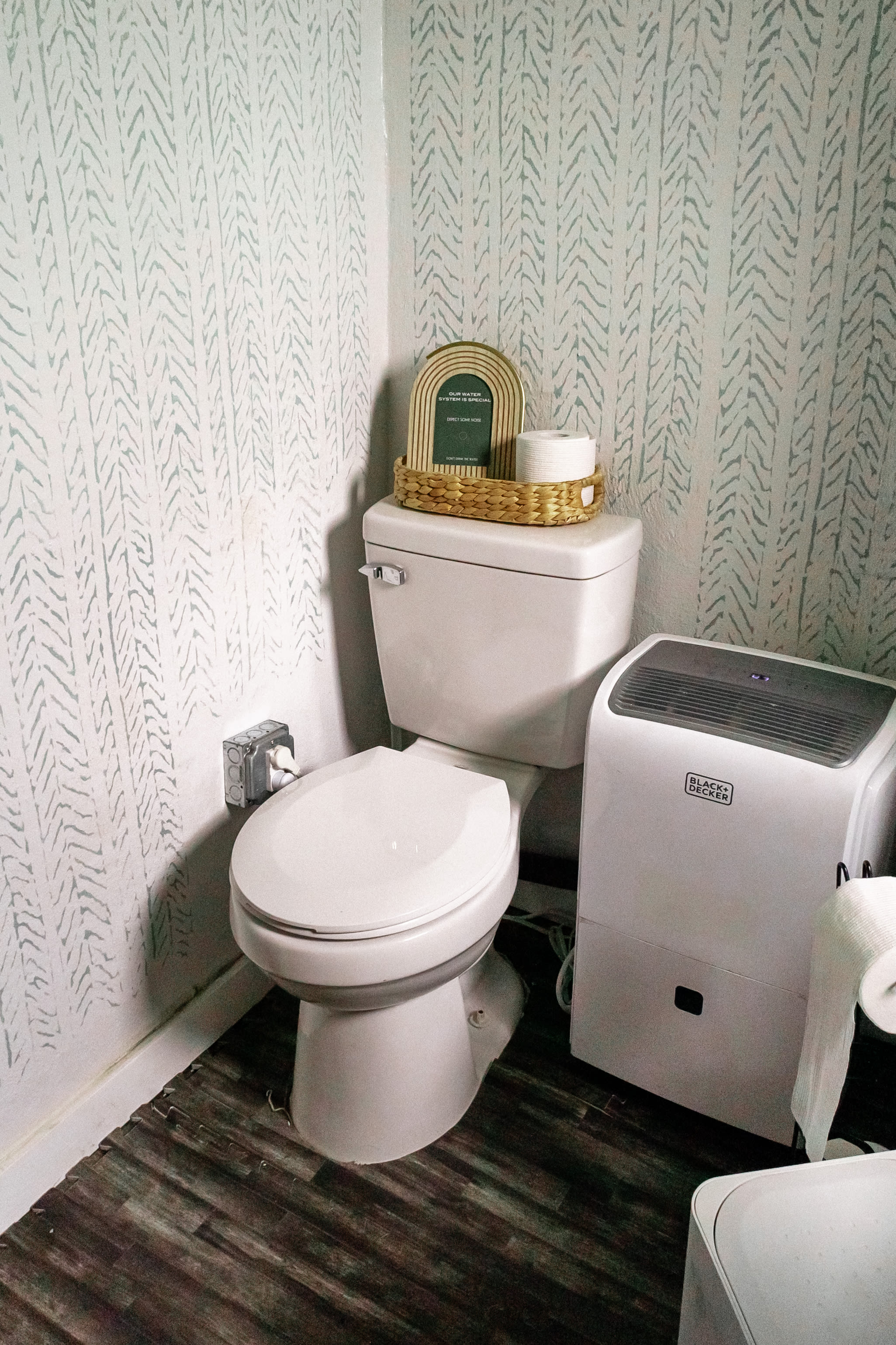 The bathroom in the lobby has a flush toilet and sink. 
