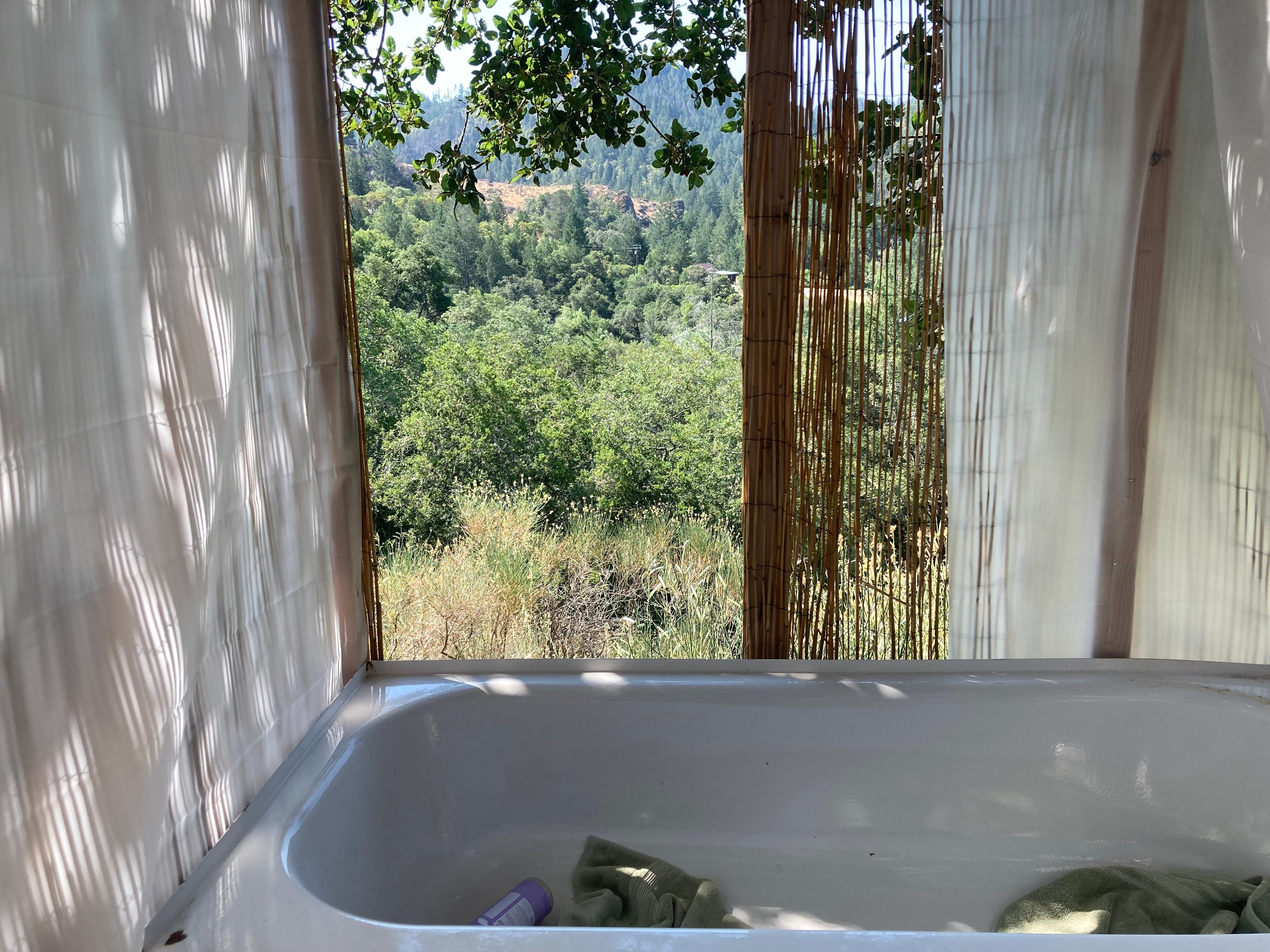 The new shower/tub combo has a privacy screen all around, except for the one outlook where there are no visible houses. 