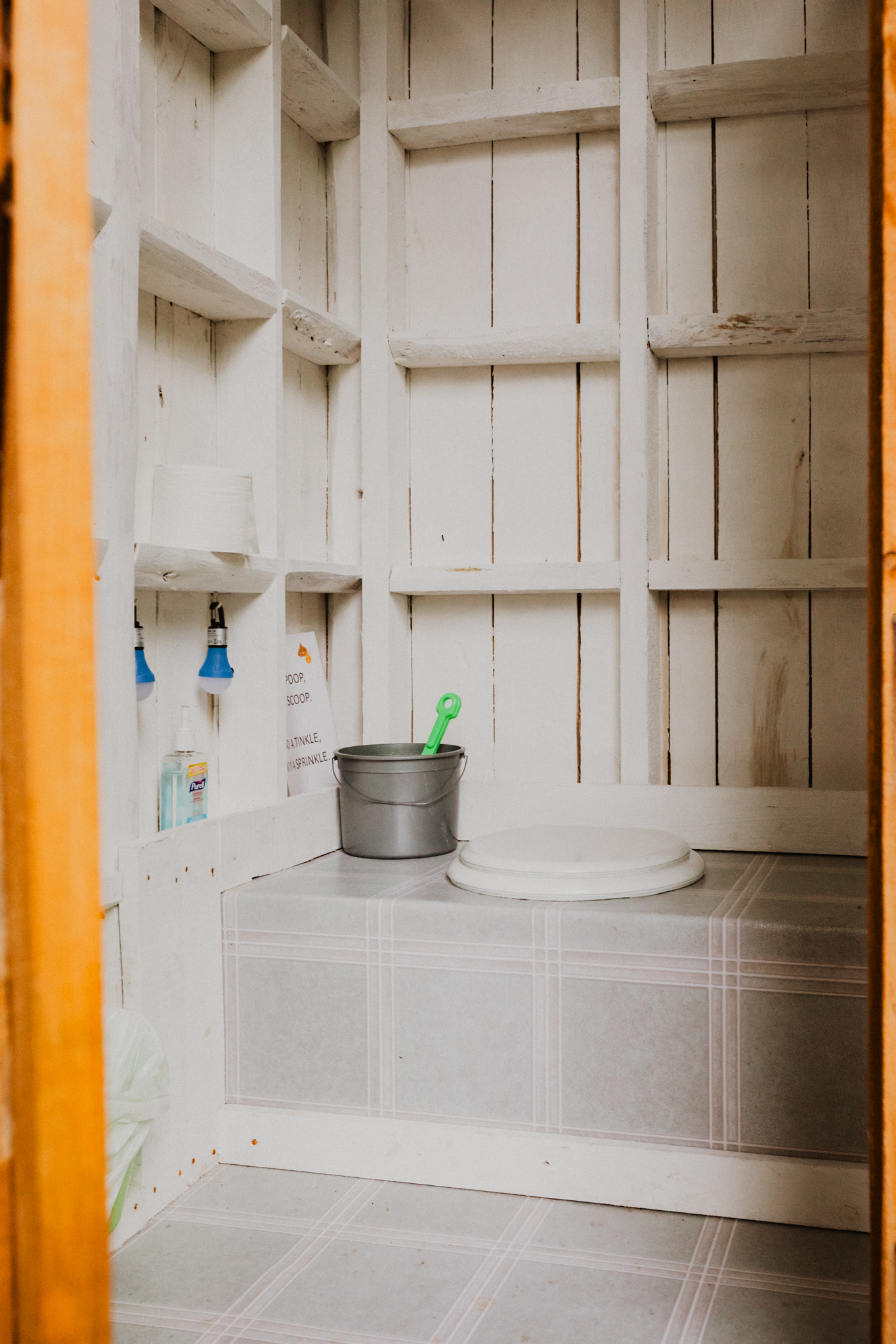 The outhouse is equipped with two flashlights for nighttime use. There is also sanitizer and a bucket with wood chips for keeping the smell down.