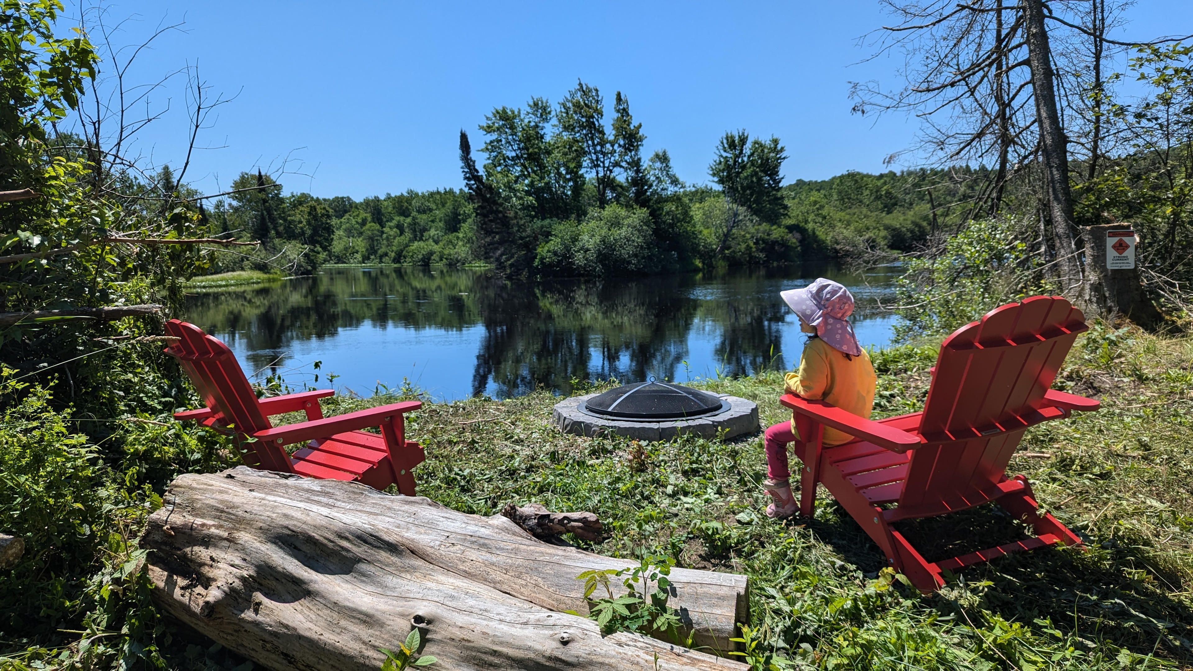 Sit on Muskoka chairs at the campfire on the edge of the Magnetawan river between Katrine and Burks Falls.  (About 20 minutes north of Huntsville) 