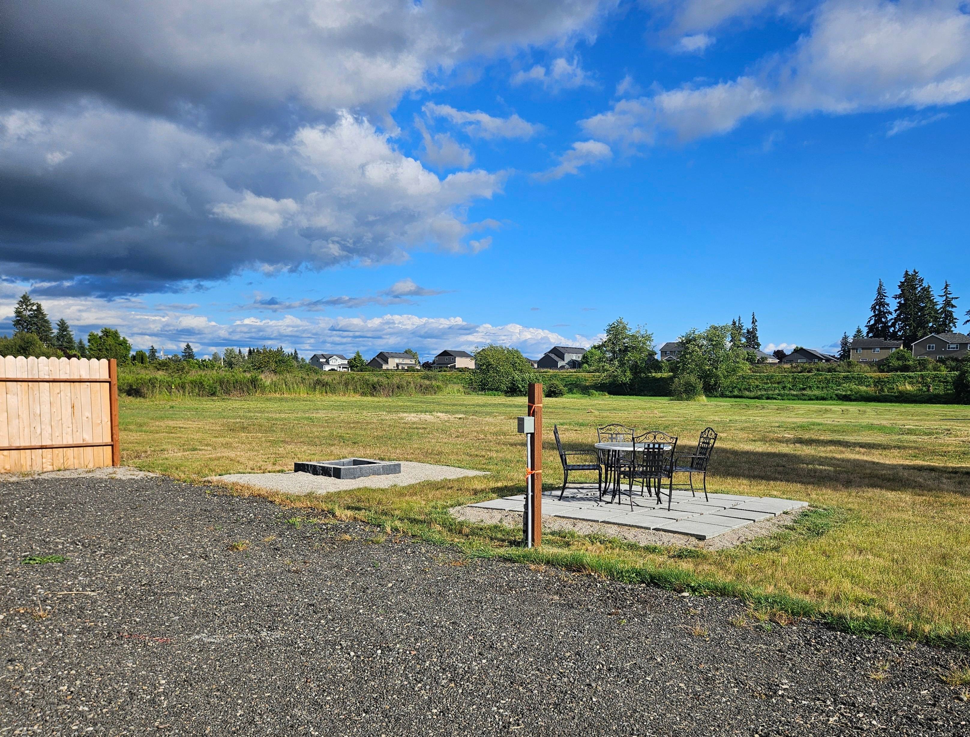 RV Pad patio with table and chairs. Fire pit for recreational burning.