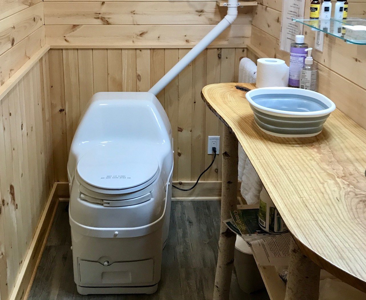 No running water in the cabin. (There's a propane-heated outdoor shower in the warm months.) Two 5-gallon water jugs are provided for guests for washing and cooking. Composting toilet is easy to use. Counter is a live slab from ash tree trunk.