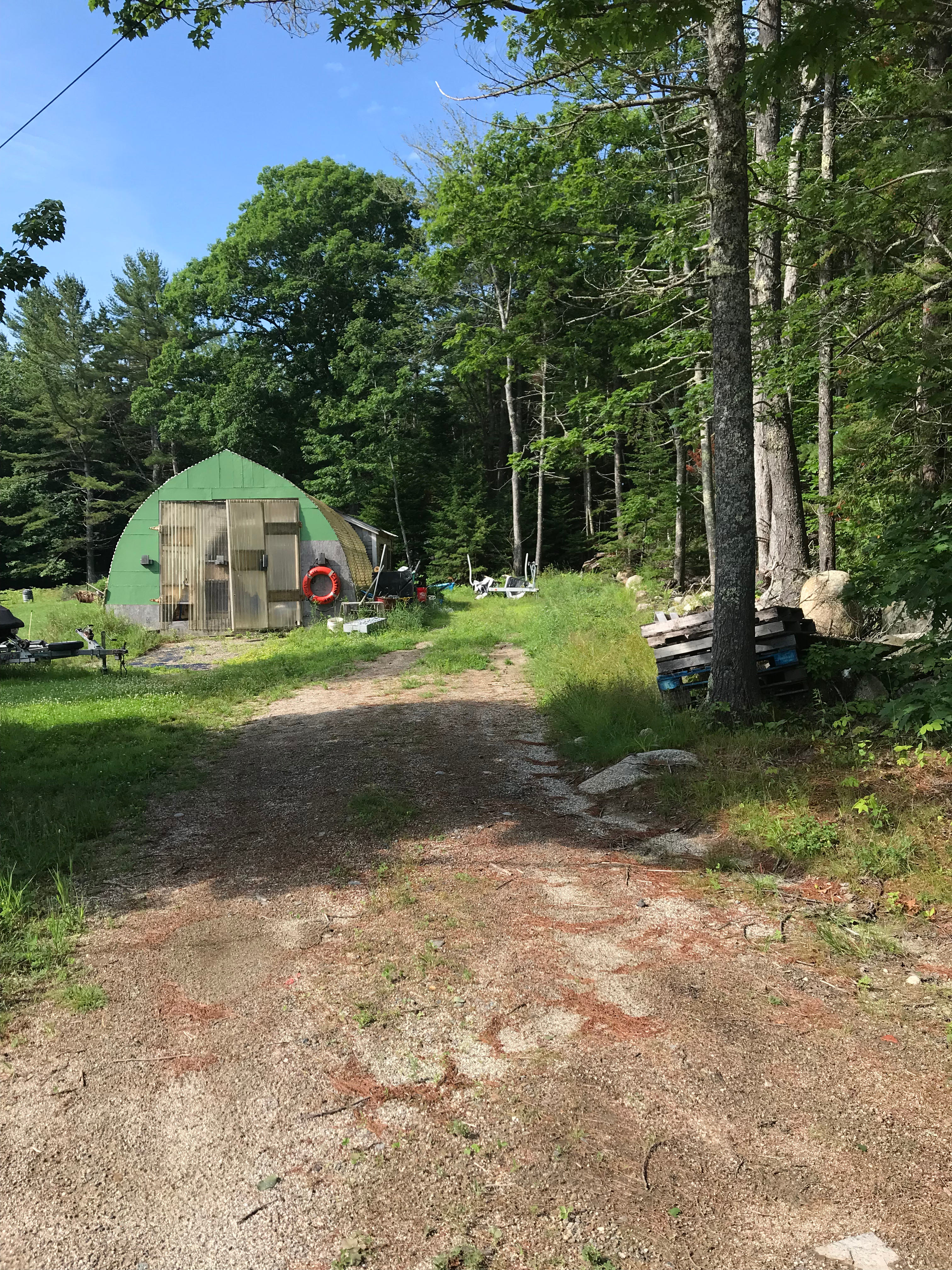Driveway. Pull straight ahead and park to the right of the structures.