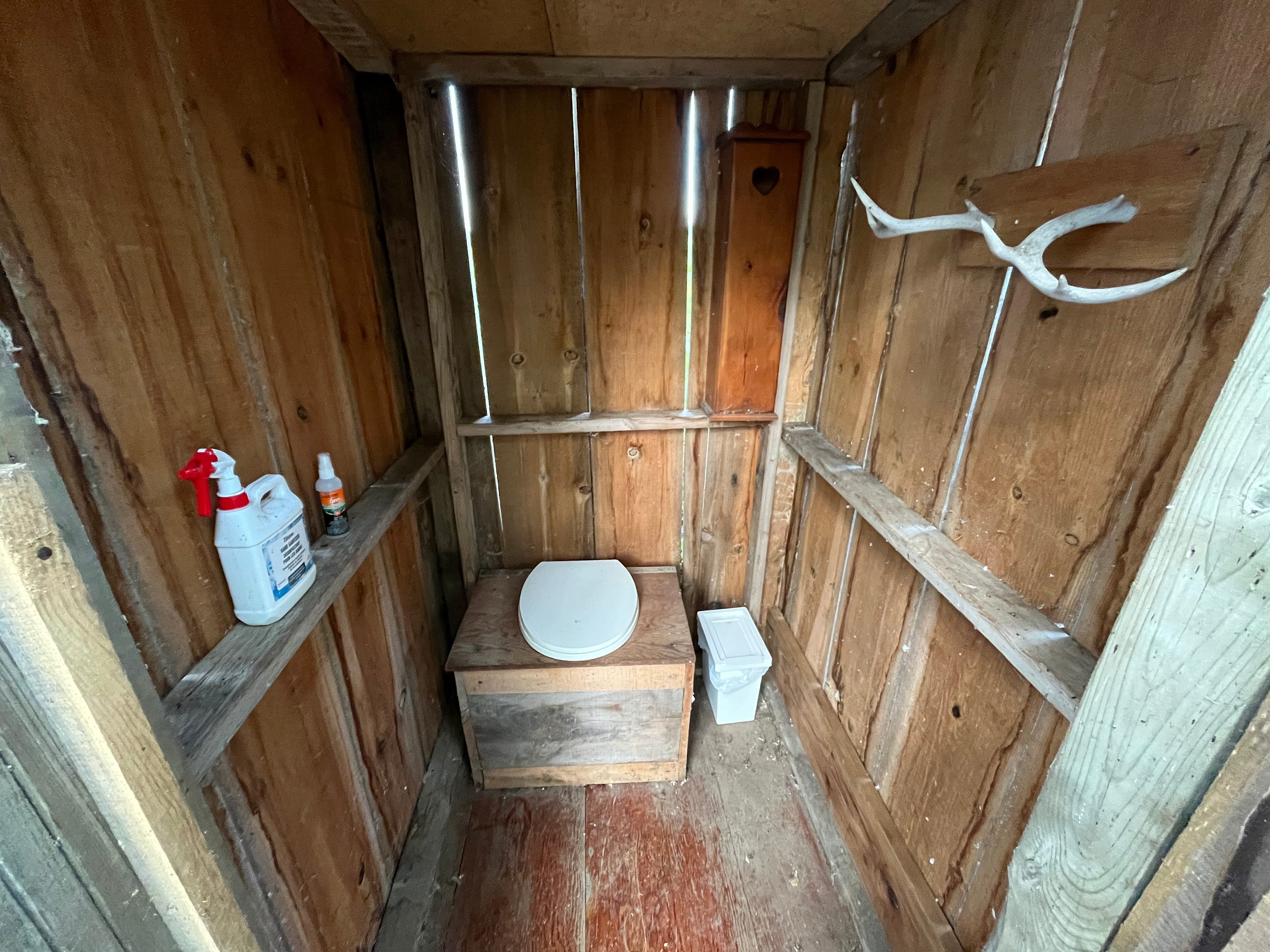 Rustic composting toilet! Appointed with paper, hand sanitizer and a bin. 