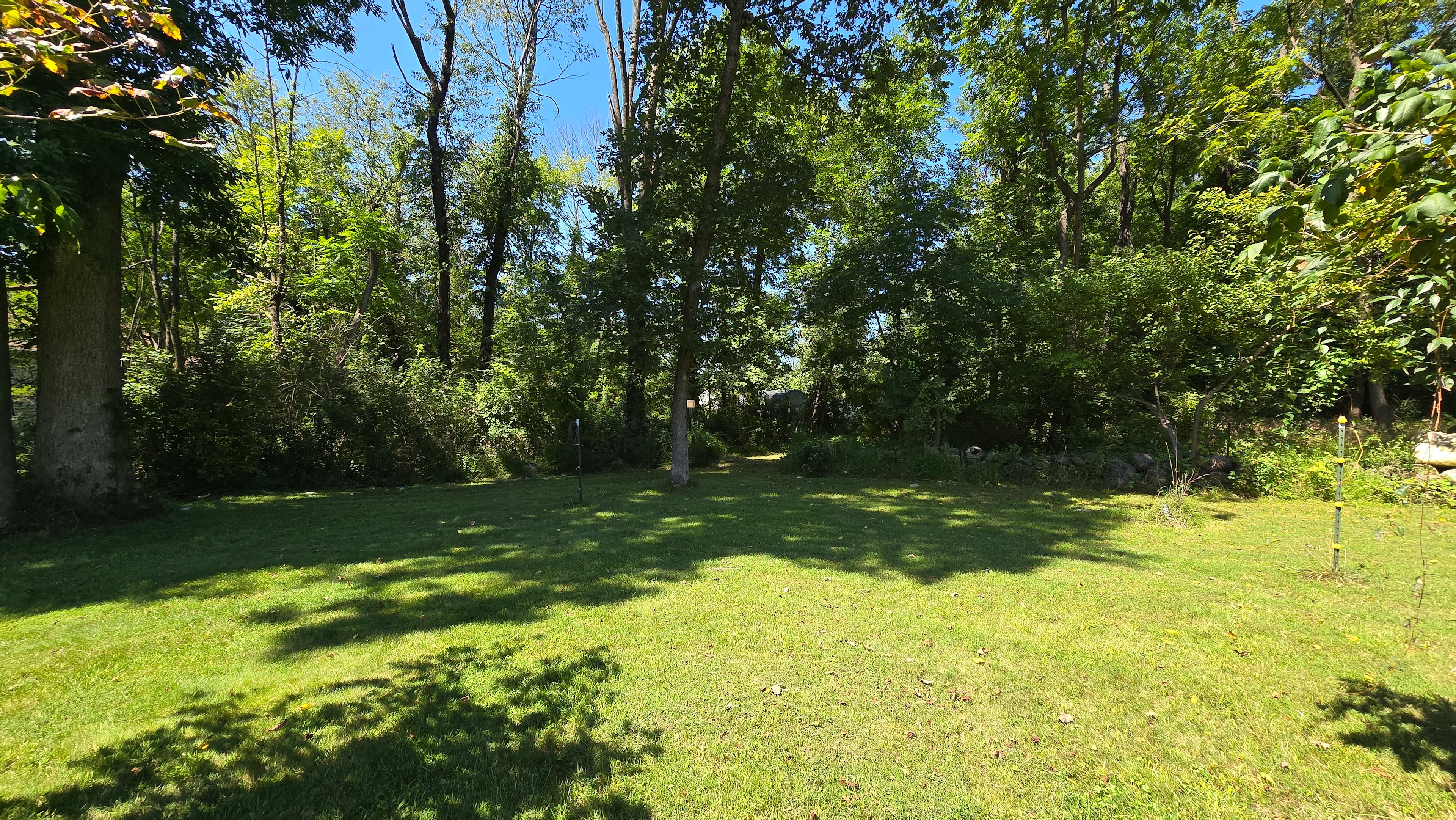 Site 4 for tents only.  40'x40' Set back with the most privacy. You can see the main house in the photo. There is a fire pit and table and chairs. 