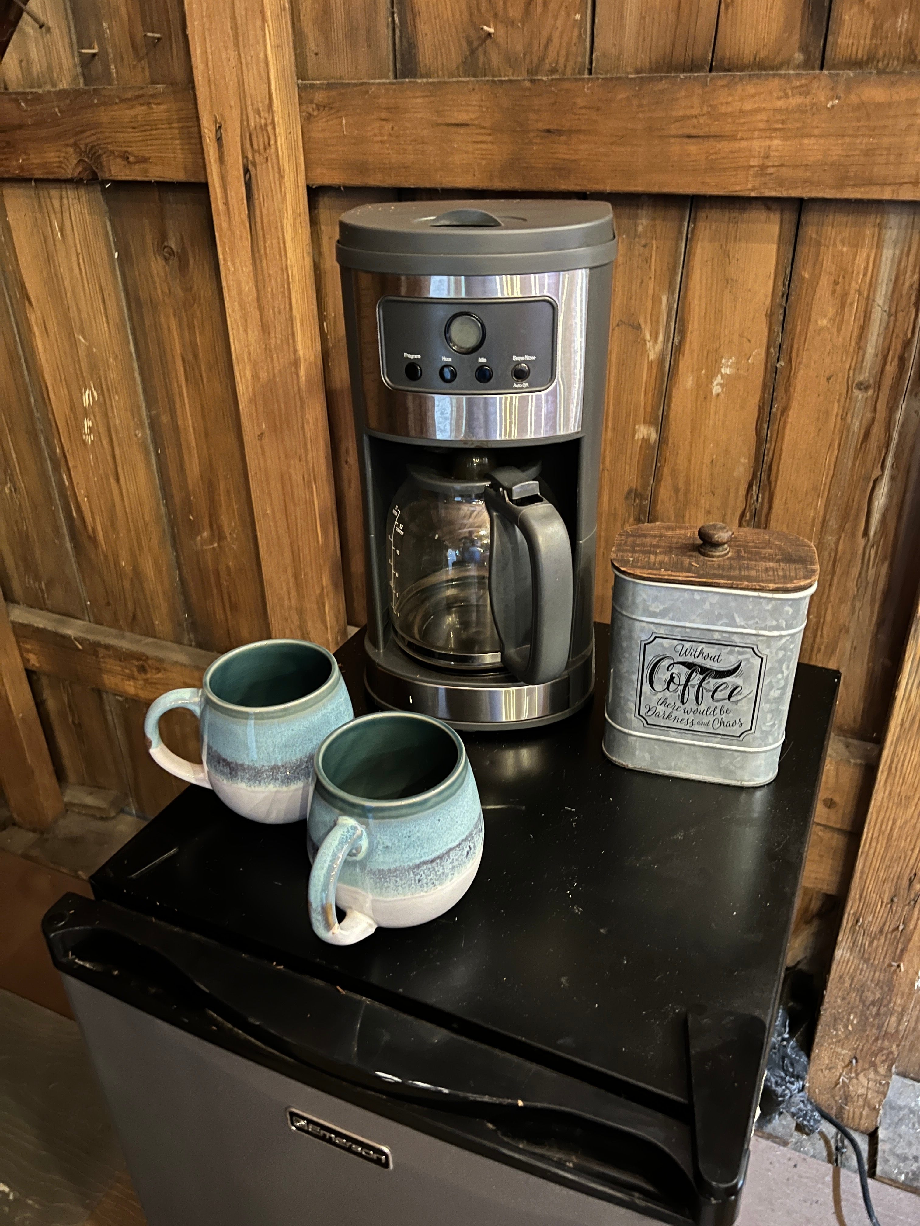 Coffee nook with fresh ground coffee, spring water in refrigerator, sugar and creamers. Two mugs await for a relaxing morning.