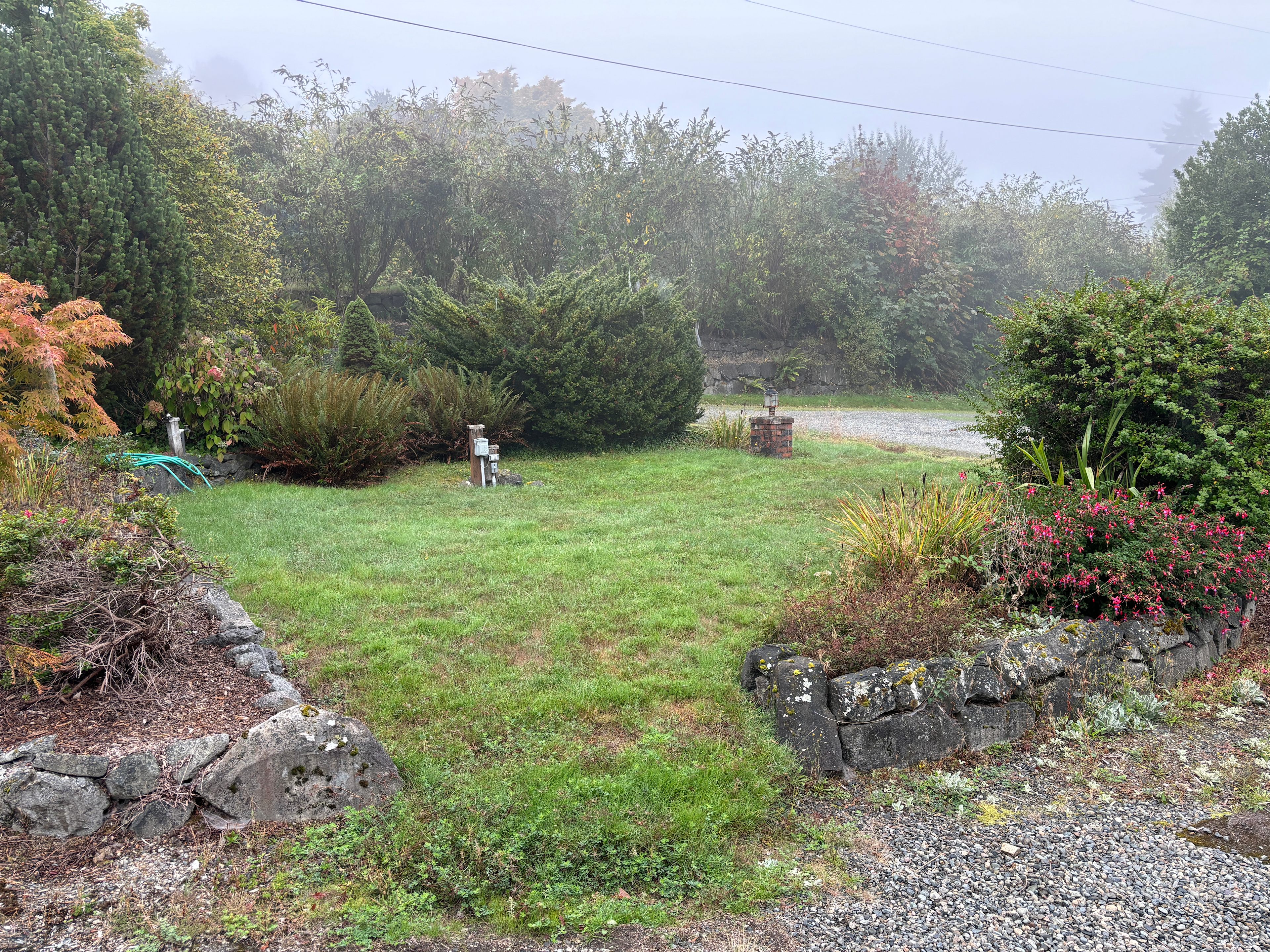 Another view of your campsite with water and electricity outlets on a foggy morning.